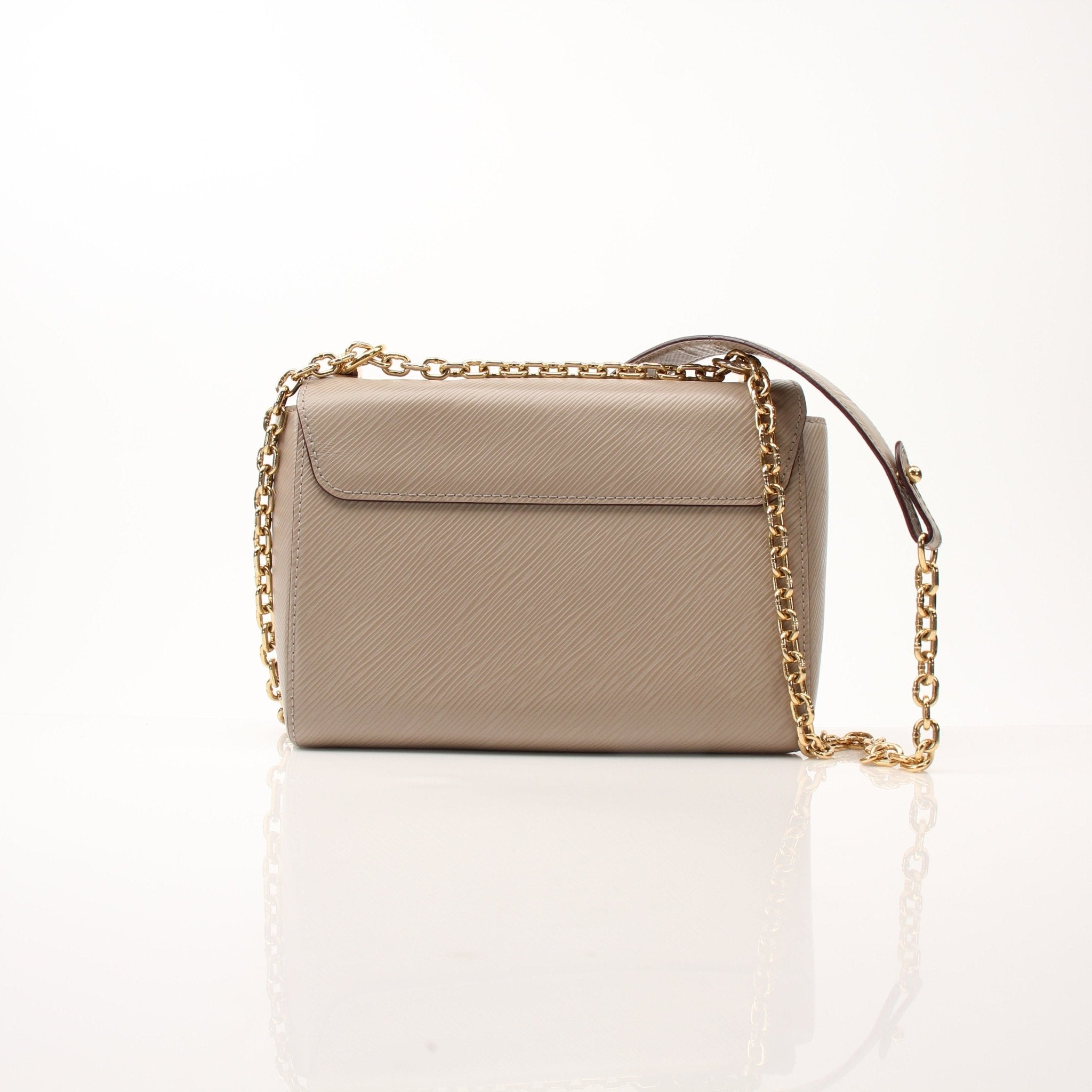 Beige Louis Vuitton Twist MM shoulder handbag with gold-tone hardware and structured design, displayed on a neutral background.