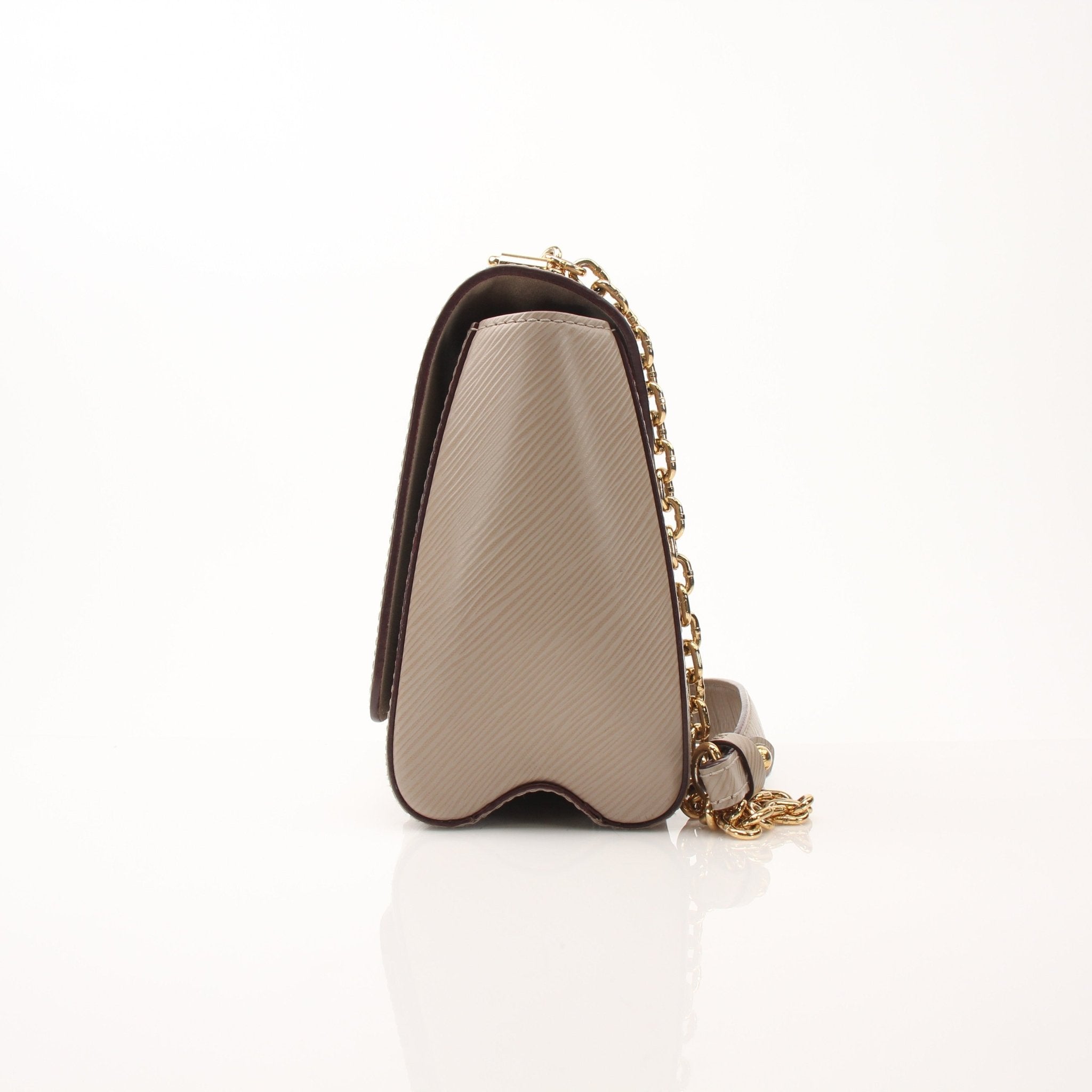 Louis Vuitton beige Twist MM shoulder handbag with gold hardware, featuring a structured design and signature monogram pattern.