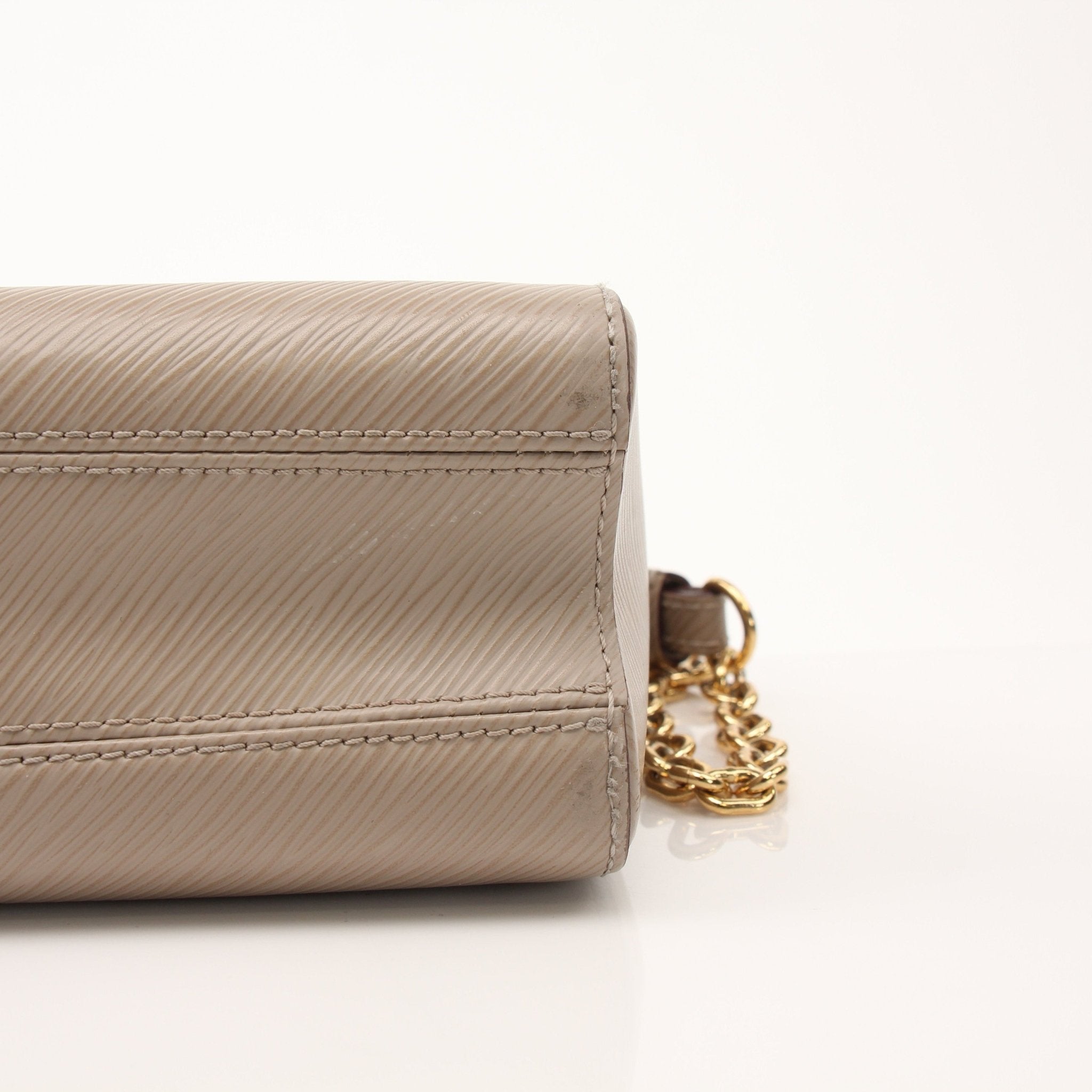Louis Vuitton Beige Twist MM shoulder handbag with gold hardware and adjustable strap, featuring the signature LV monogram pattern.