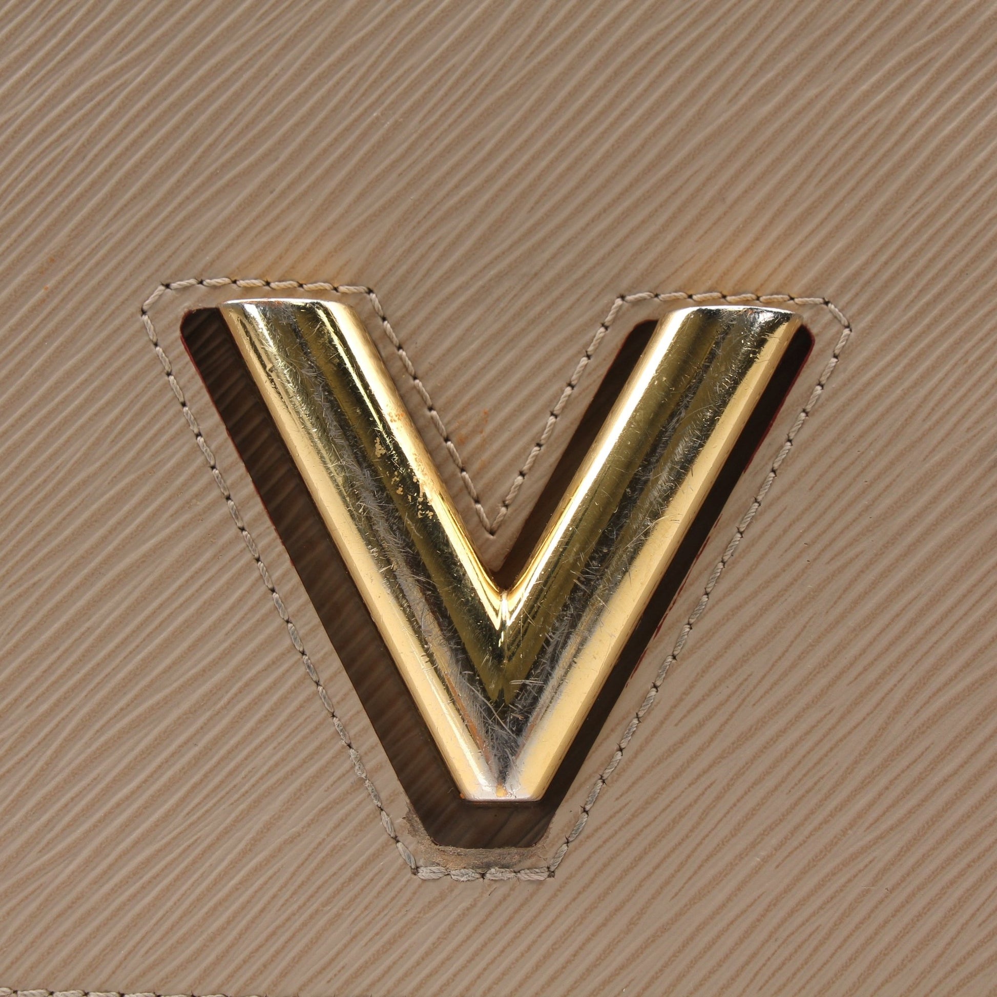 Louis Vuitton beige Twist MM shoulder handbag with gold hardware, featuring signature monogram canvas and top handle.
