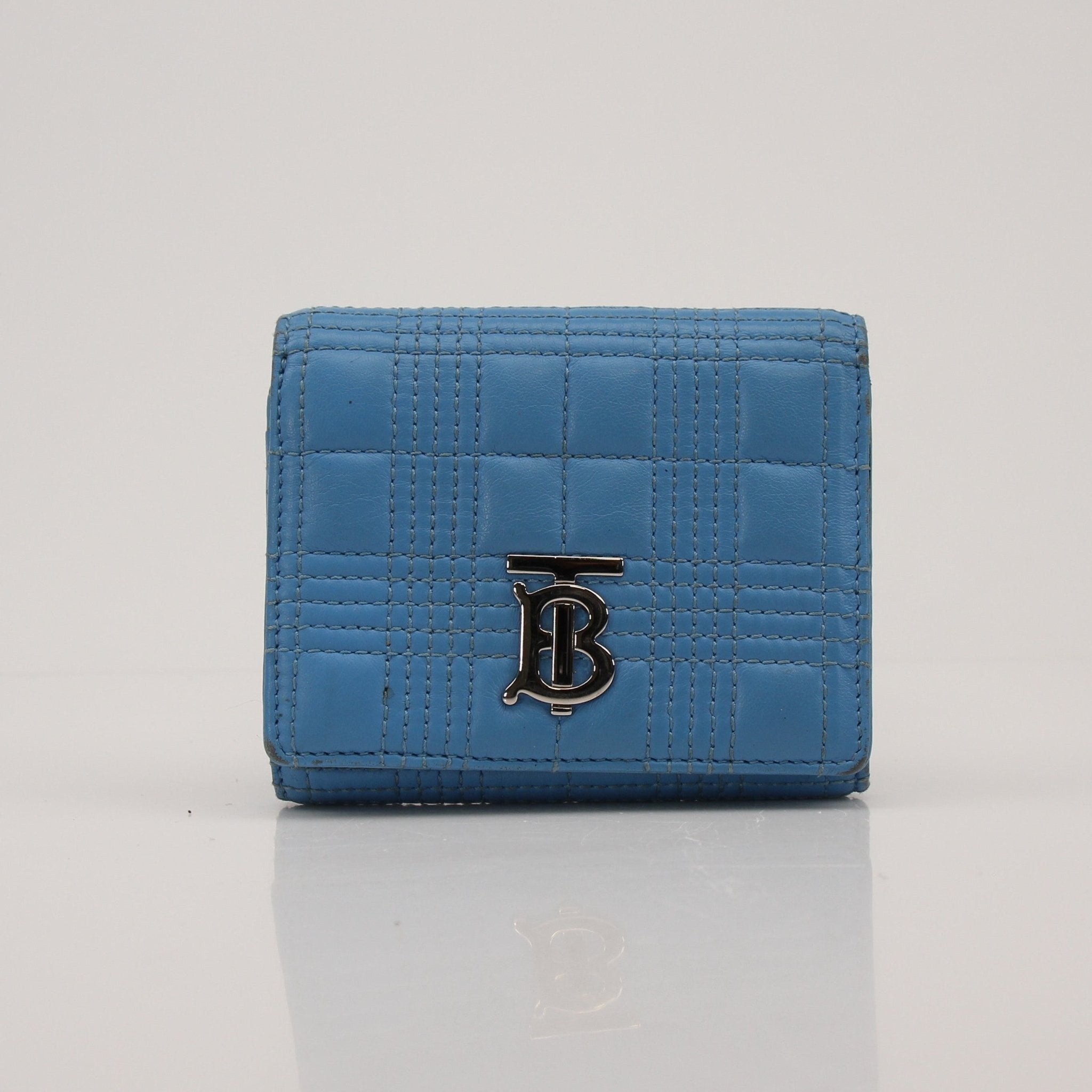 Gold & Beyond Lola Wallet featuring a sleek design with textured leather and gold-tone accents, shown in a close-up image.