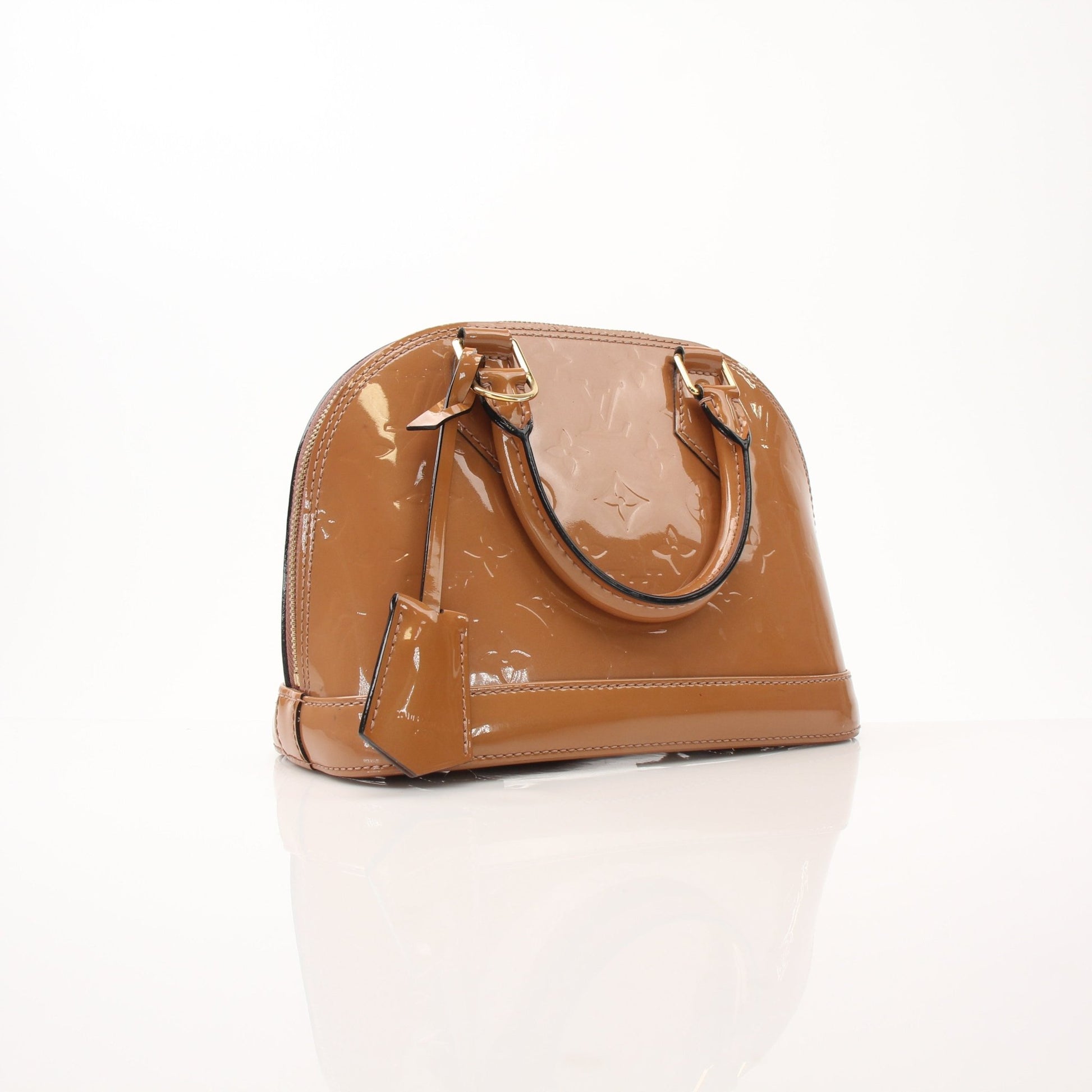Louis Vuitton Rose Vernis Alma BB handbag with gold hardware and structured design, featuring the signature glossy finish and elegant shape.