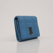 Gold & Beyond Burberry Lola Wallet featuring a sleek design with multiple card slots and a signature check pattern.