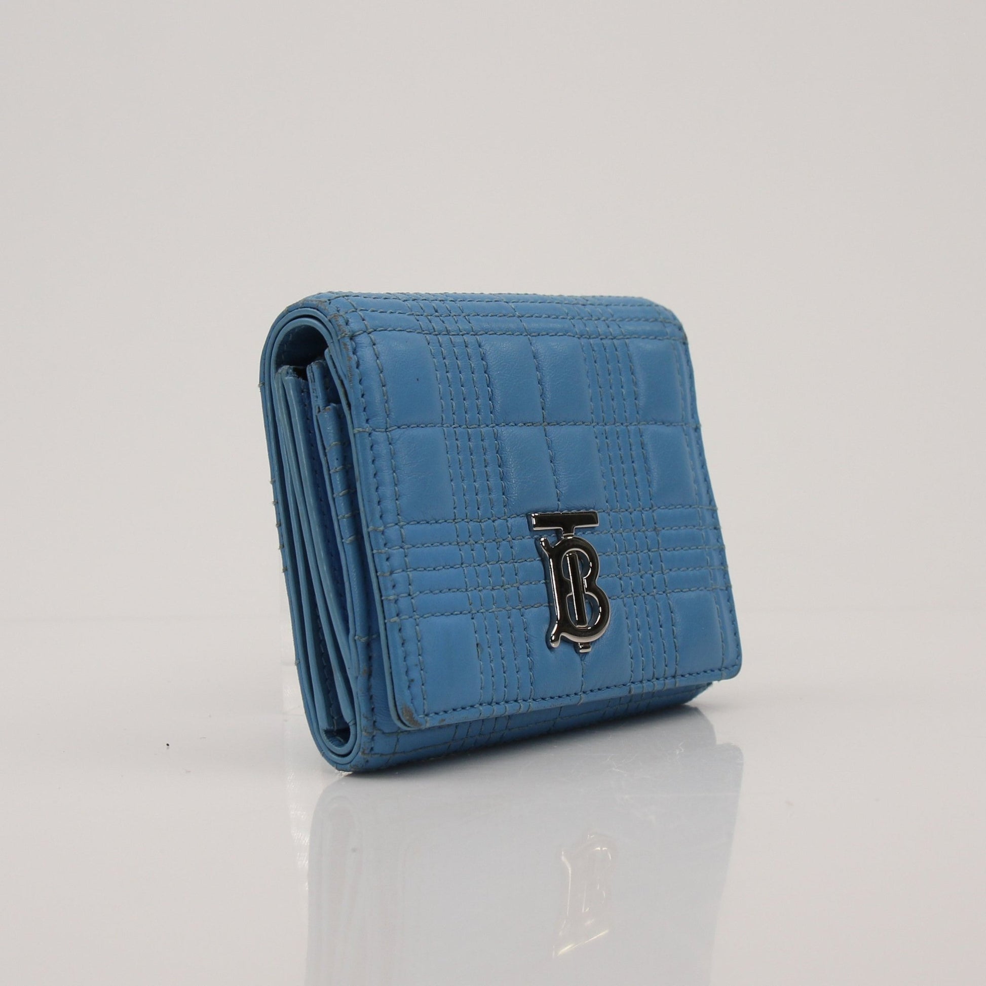 Gold & Beyond Burberry Lola Wallet featuring a sleek design with multiple card slots and a signature check pattern.