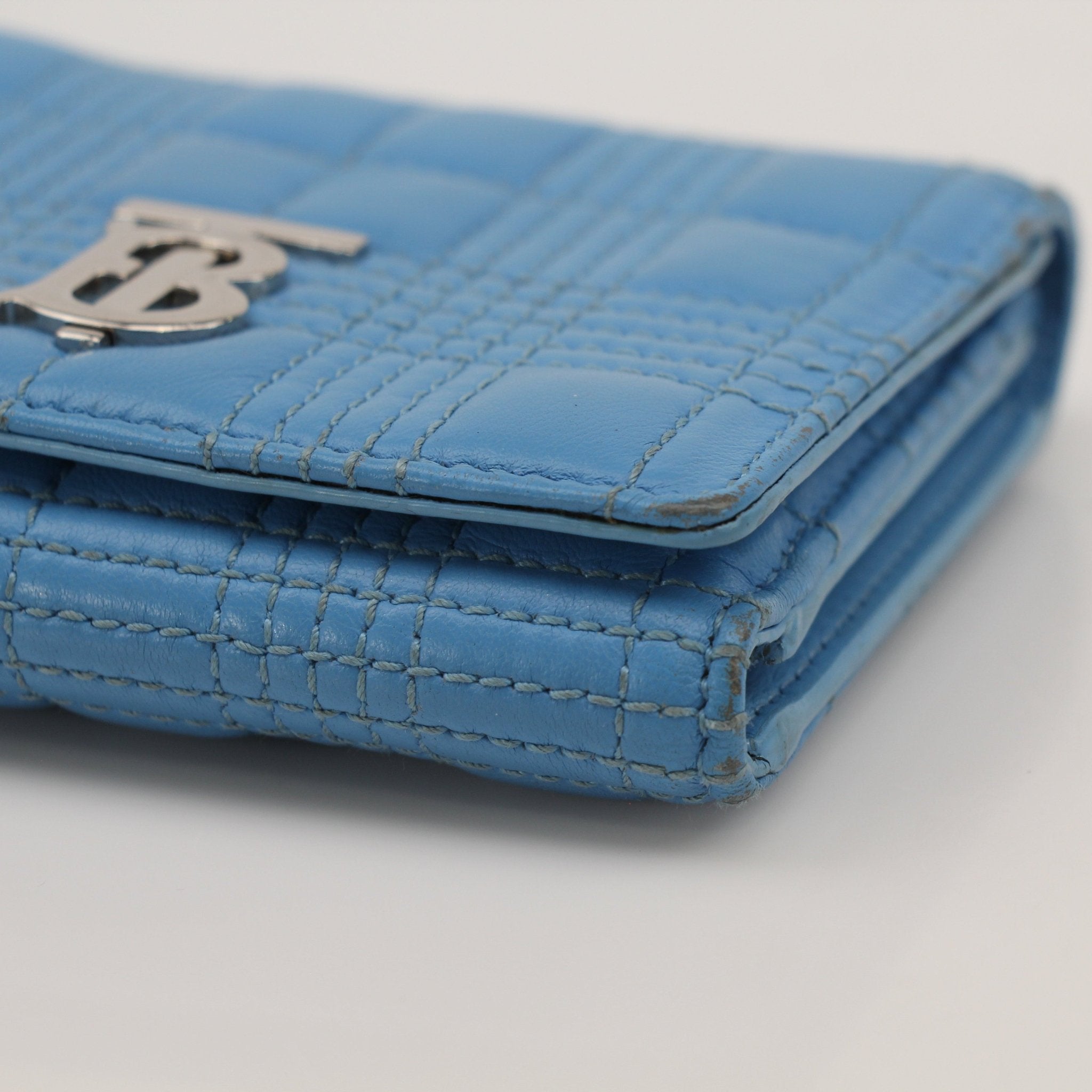 Gold & Beyond Burberry Lola Wallet featuring a sleek leather design with gold accents and multiple card slots.