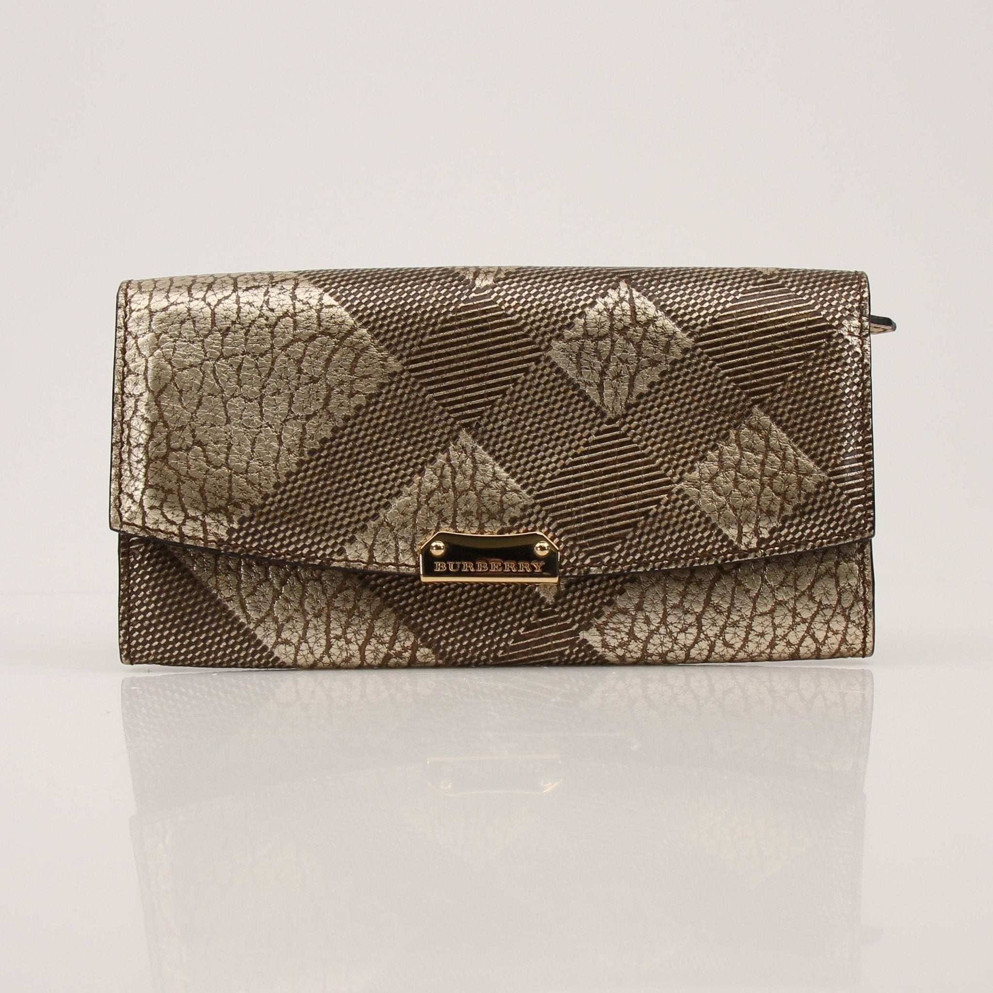 Gold & Beyond Burberry Continental Wallet showing brown leather exterior with multiple card slots and a gold logo emblem.