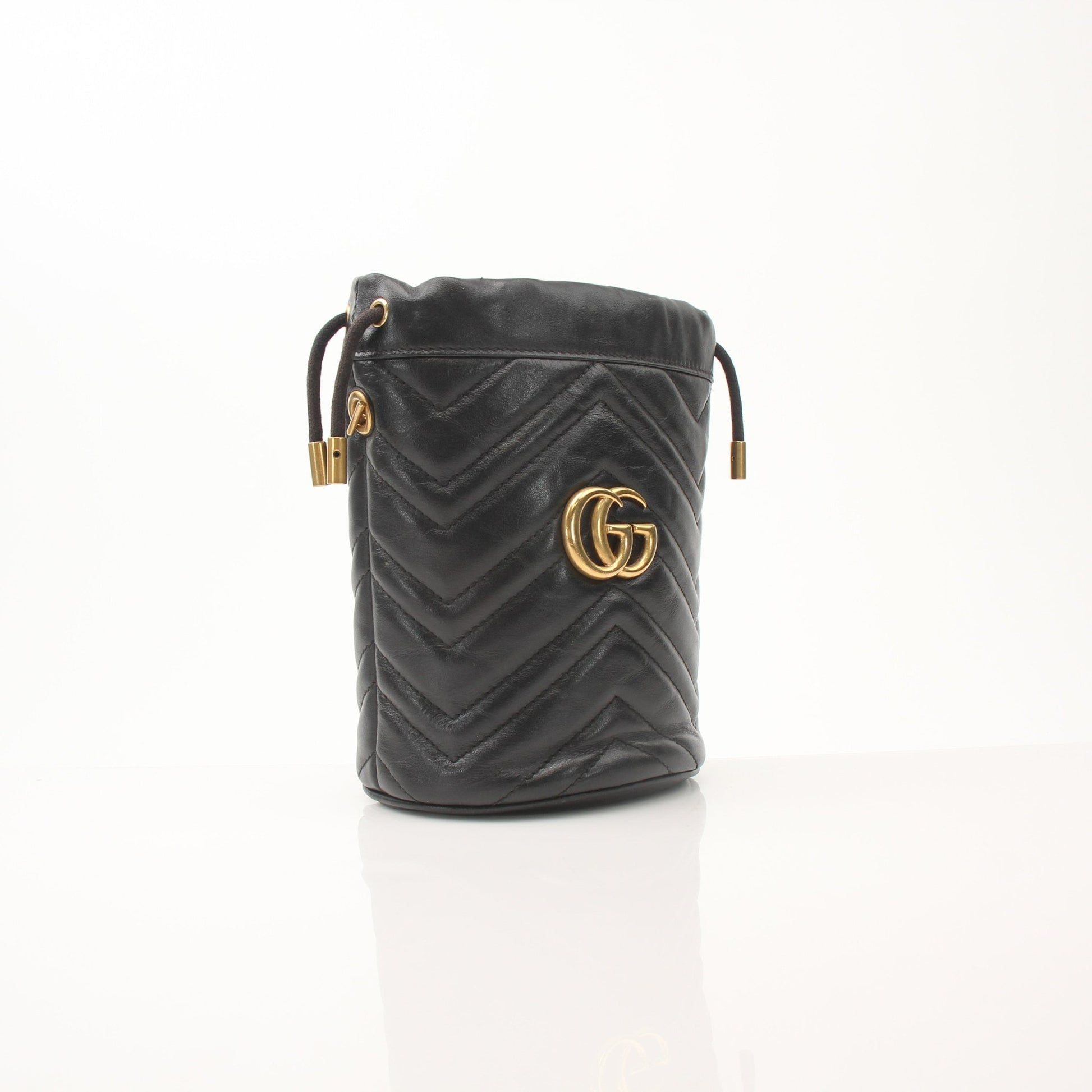 Gold & Beyond Gucci GG Marmont small bucket handbag with quilted leather and gold hardware, stylish and compact for everyday use.