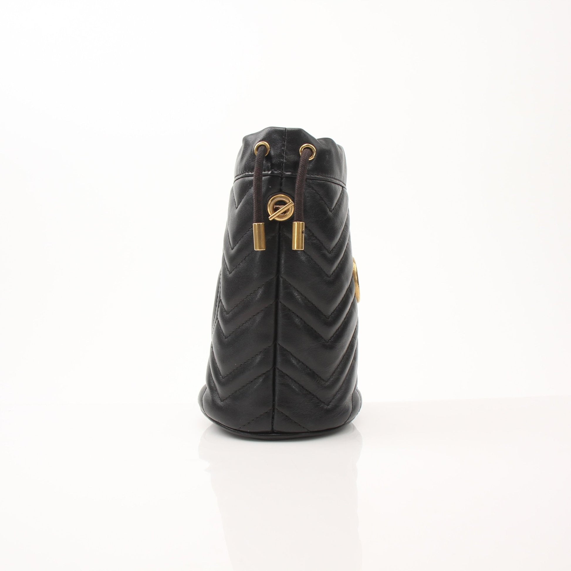 Gucci GG Marmont small bucket handbag with chain strap and chevron quilted leather, black color, designer luxury accessory.