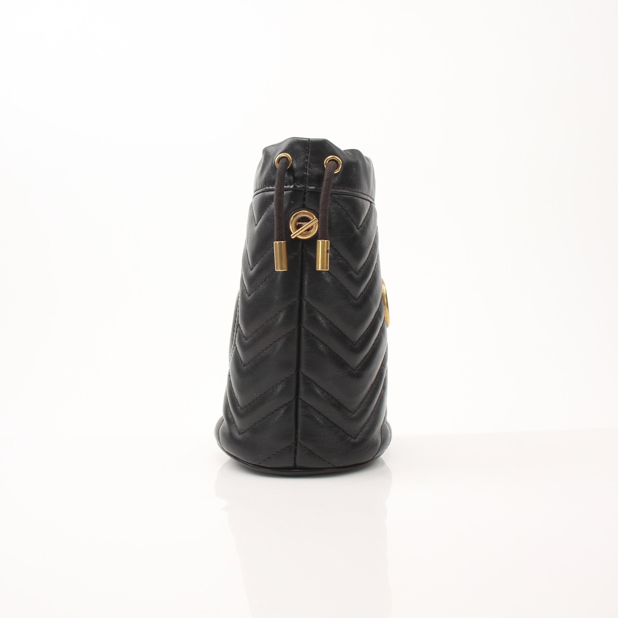 Gucci GG Marmont small bucket handbag with chain strap and chevron quilted leather, black color, designer luxury accessory.