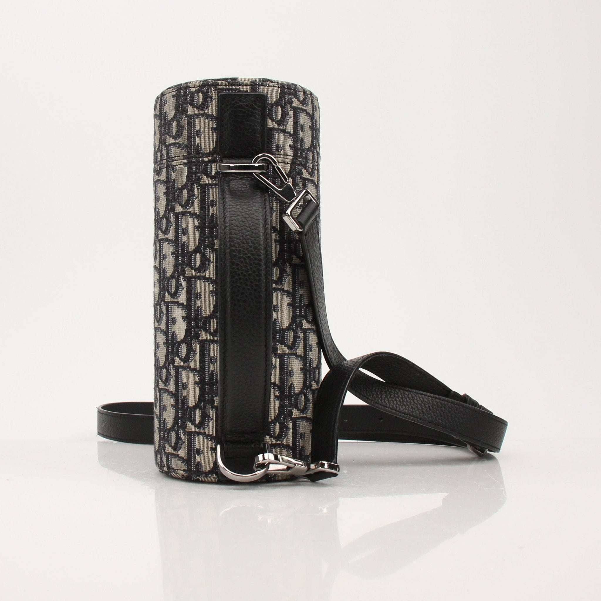 Christian Dior Oblique vertical crossbody handbag with gold hardware and adjustable strap, shown on a neutral background.