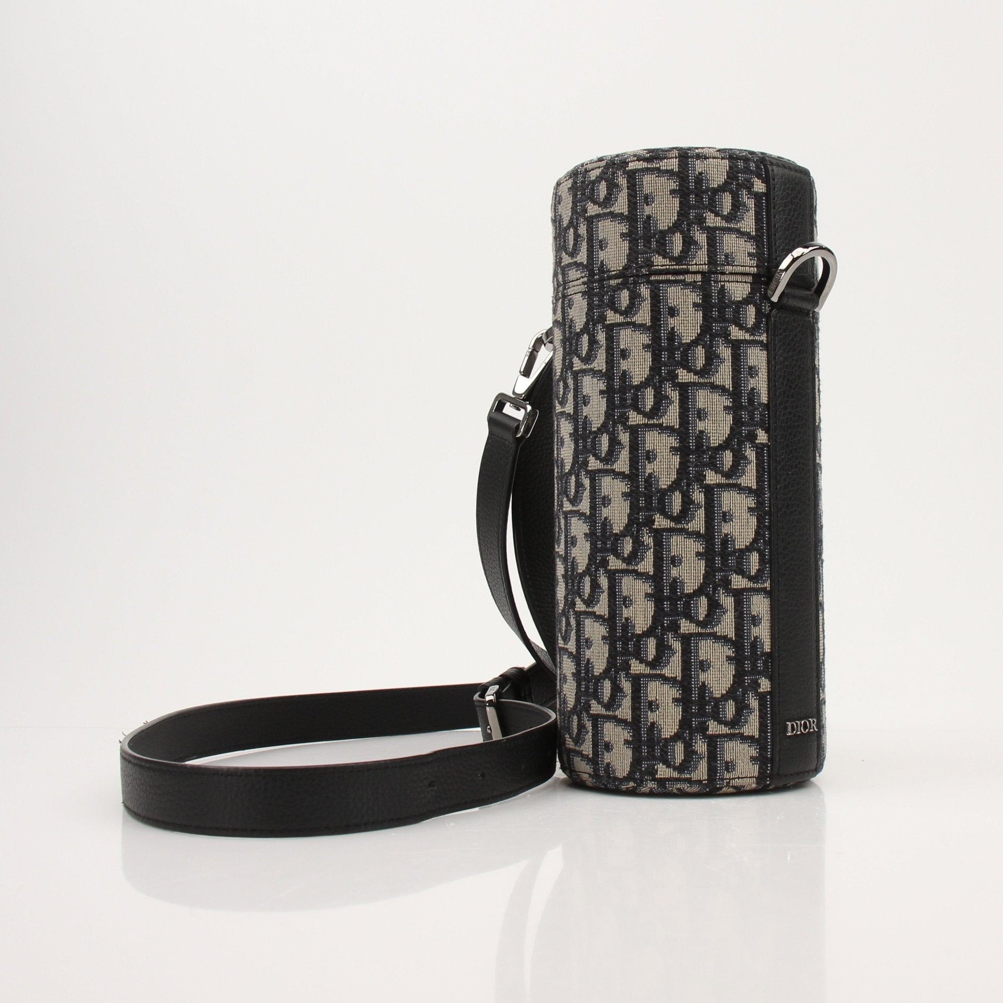 Gold & Beyond Christian Dior Oblique Vertical Crossbody handbag with adjustable strap and logo detail, showcasing elegant designer style.