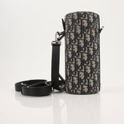 Christian Dior Oblique vertical crossbody handbag in beige and brown with gold hardware, featuring the signature Dior pattern.