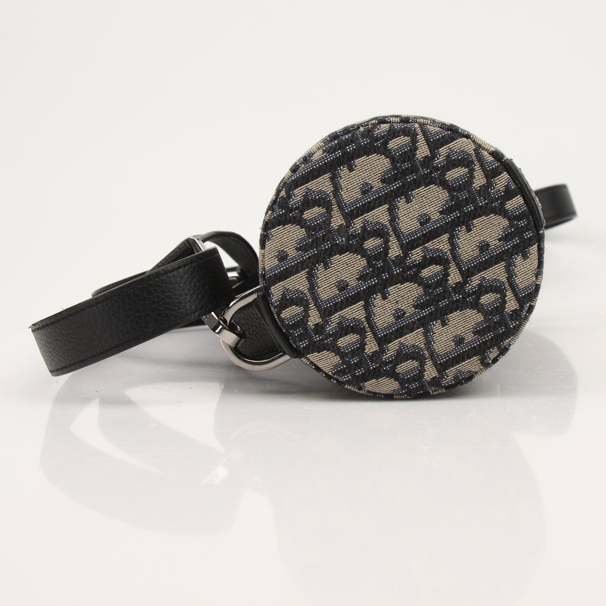 Christian Dior Oblique vertical crossbody handbag with gold accents and adjustable strap, featuring the iconic Dior monogram pattern.