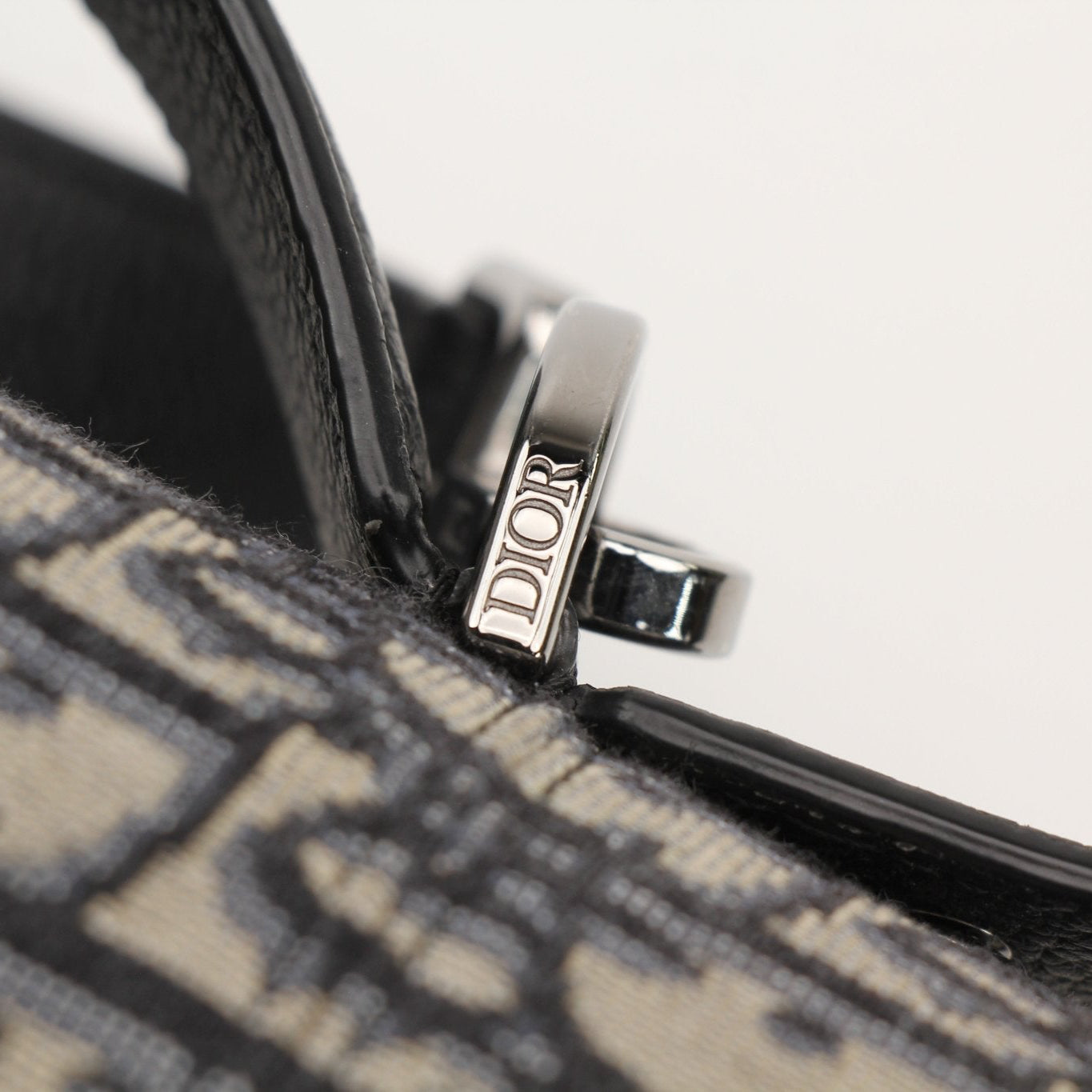 Christian Dior Oblique vertical crossbody handbag with gold hardware and adjustable strap, showcasing elegant designer craftsmanship.