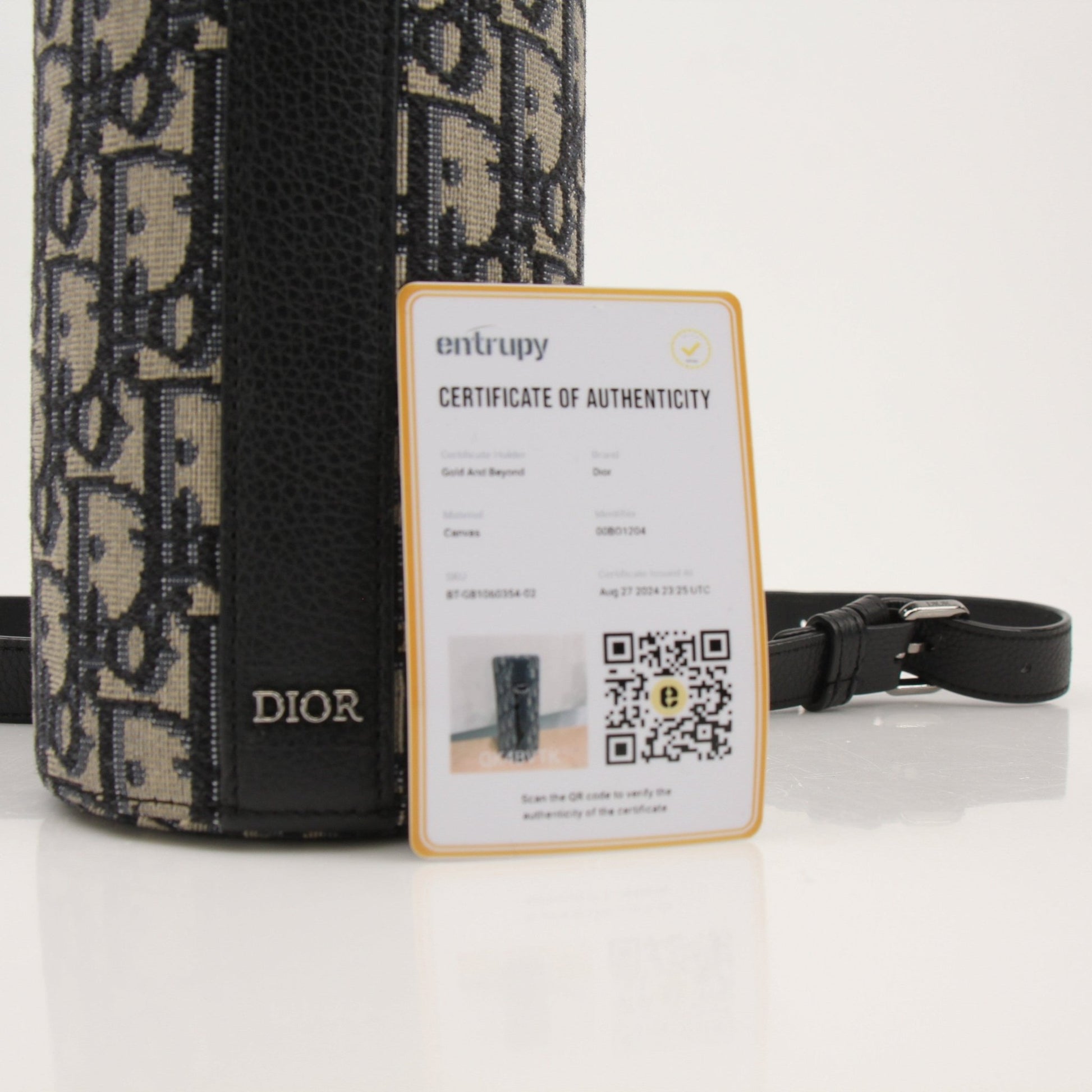 Christian Dior Oblique vertical crossbody handbag with gold accents and adjustable strap, featuring iconic Dior monogram pattern.