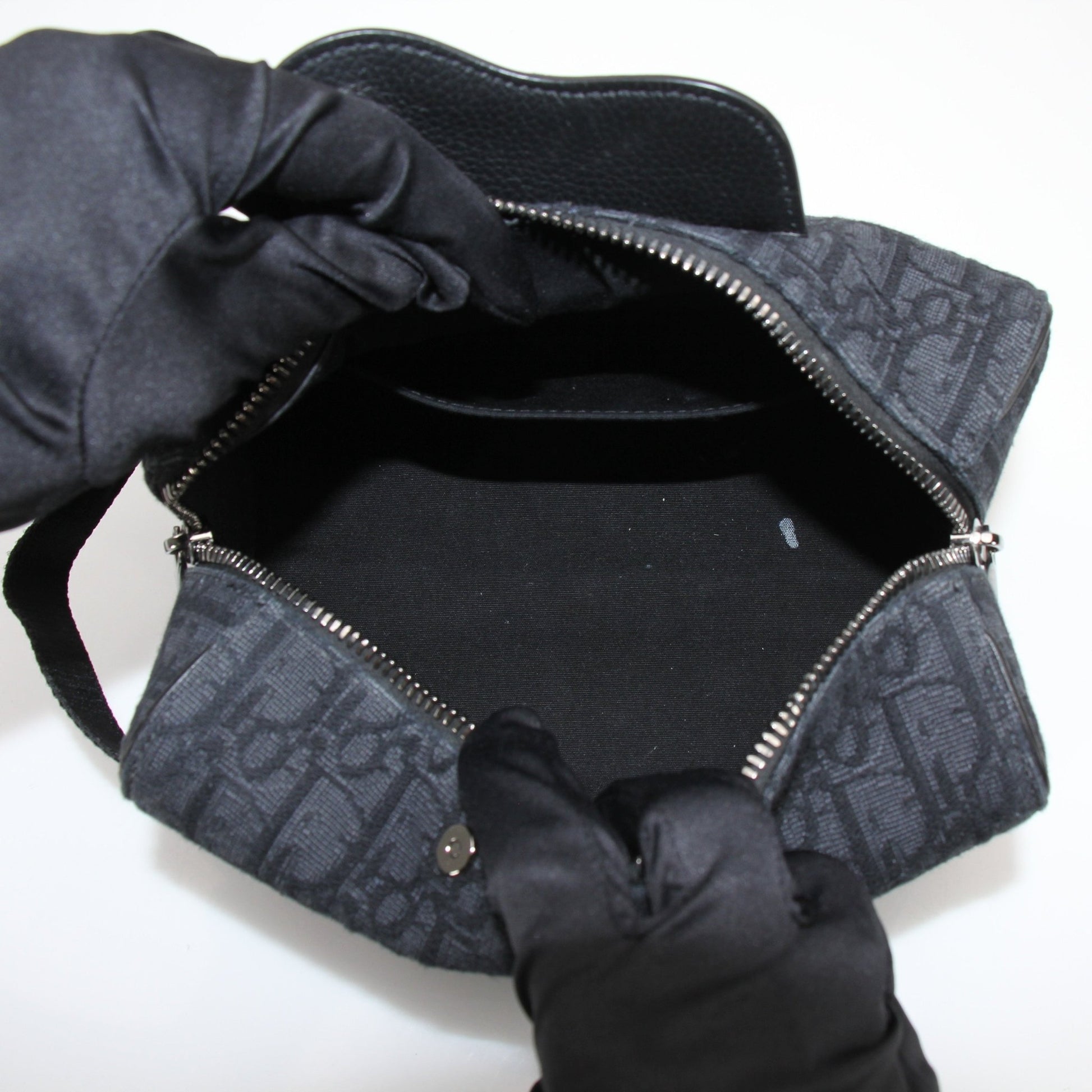 Christian Dior Dior Oblique toiletry bag with gold accents, showcasing the iconic print and compact handbag design.
