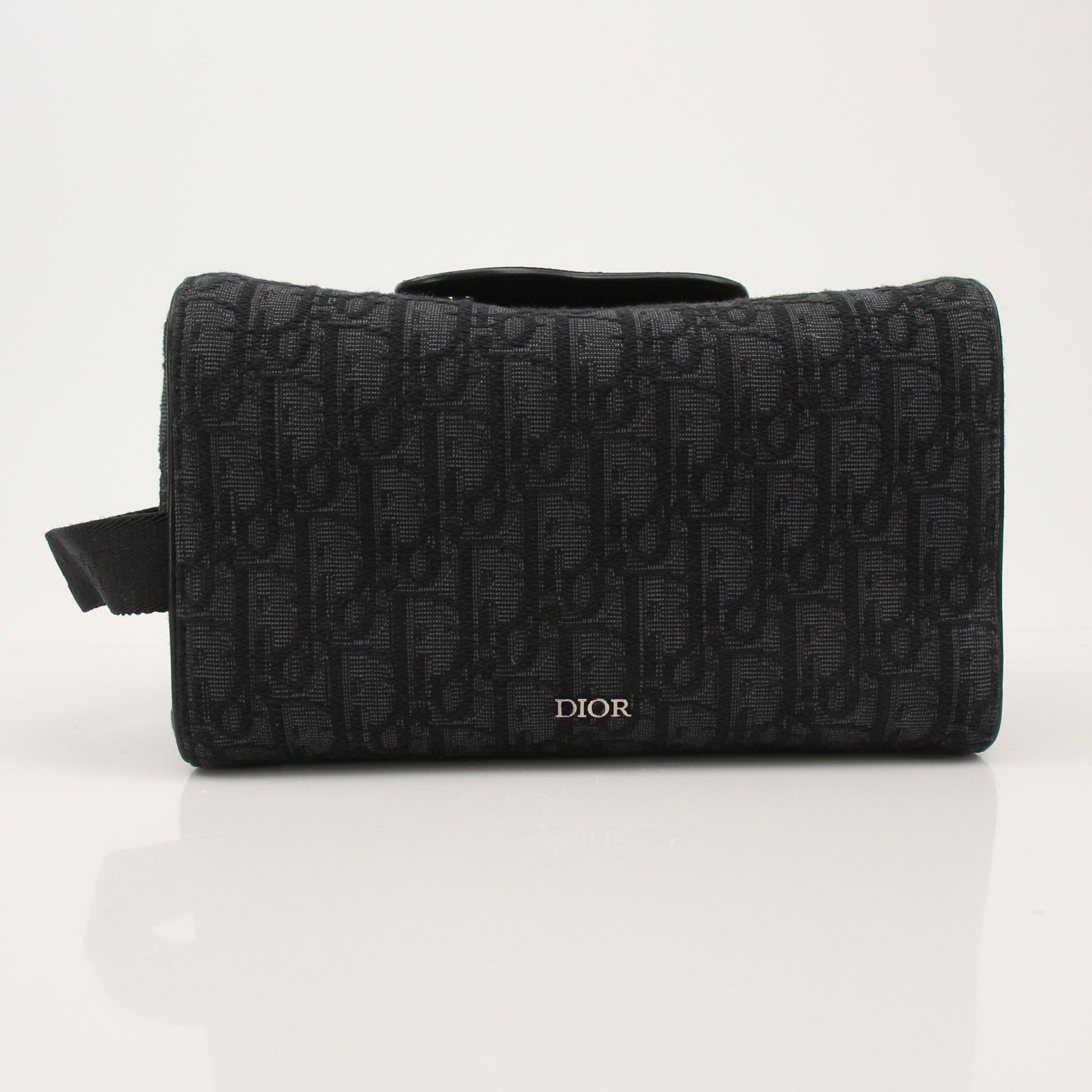 Christian Dior Dior Oblique toiletry bag with gold accents, featuring the signature monogram pattern and compact handbag design.