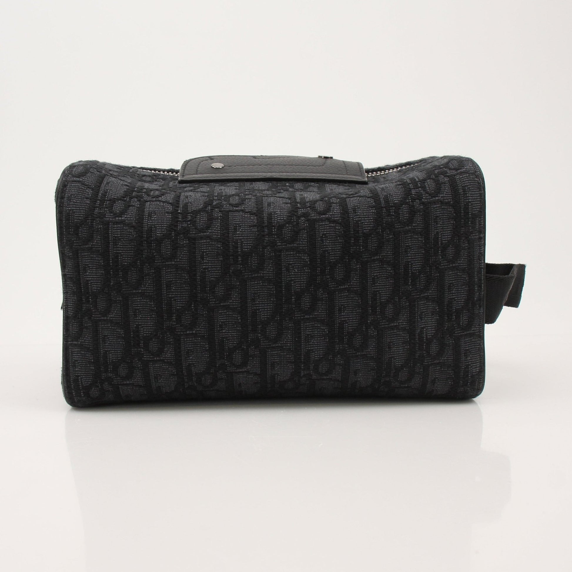 Christian Dior Dior Oblique toiletry bag with gold accents, featuring the iconic monogram pattern and compact handbag design.