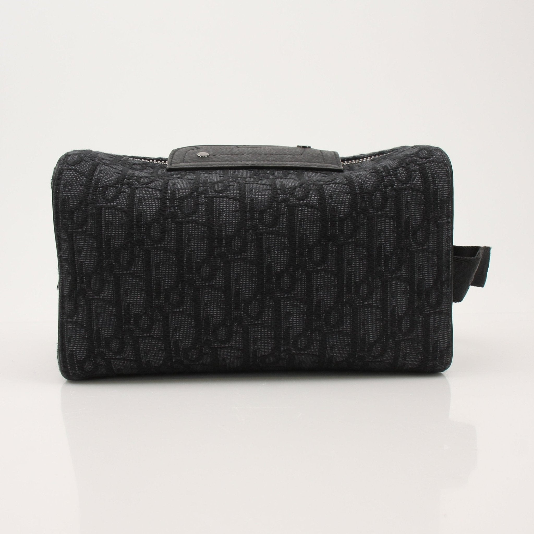 Christian Dior Dior Oblique toiletry bag with gold accents, featuring the iconic monogram pattern and compact handbag design.