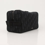 Christian Dior Dior Oblique toiletry bag with gold accents, featuring the signature Dior Oblique pattern and compact handbag design.