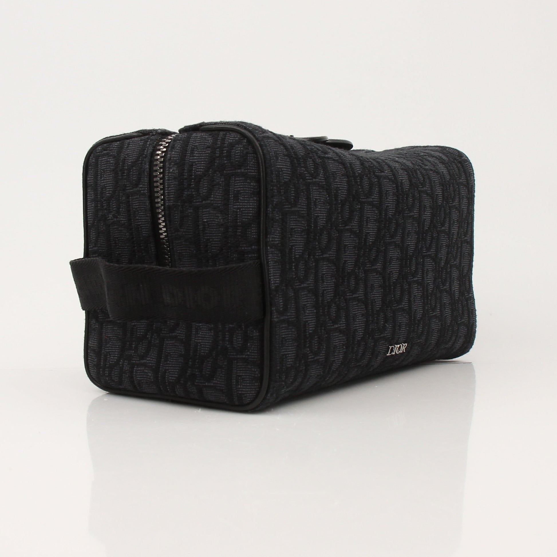 Christian Dior Dior Oblique toiletry bag with gold accents, featuring the signature Dior Oblique pattern and compact handbag design.