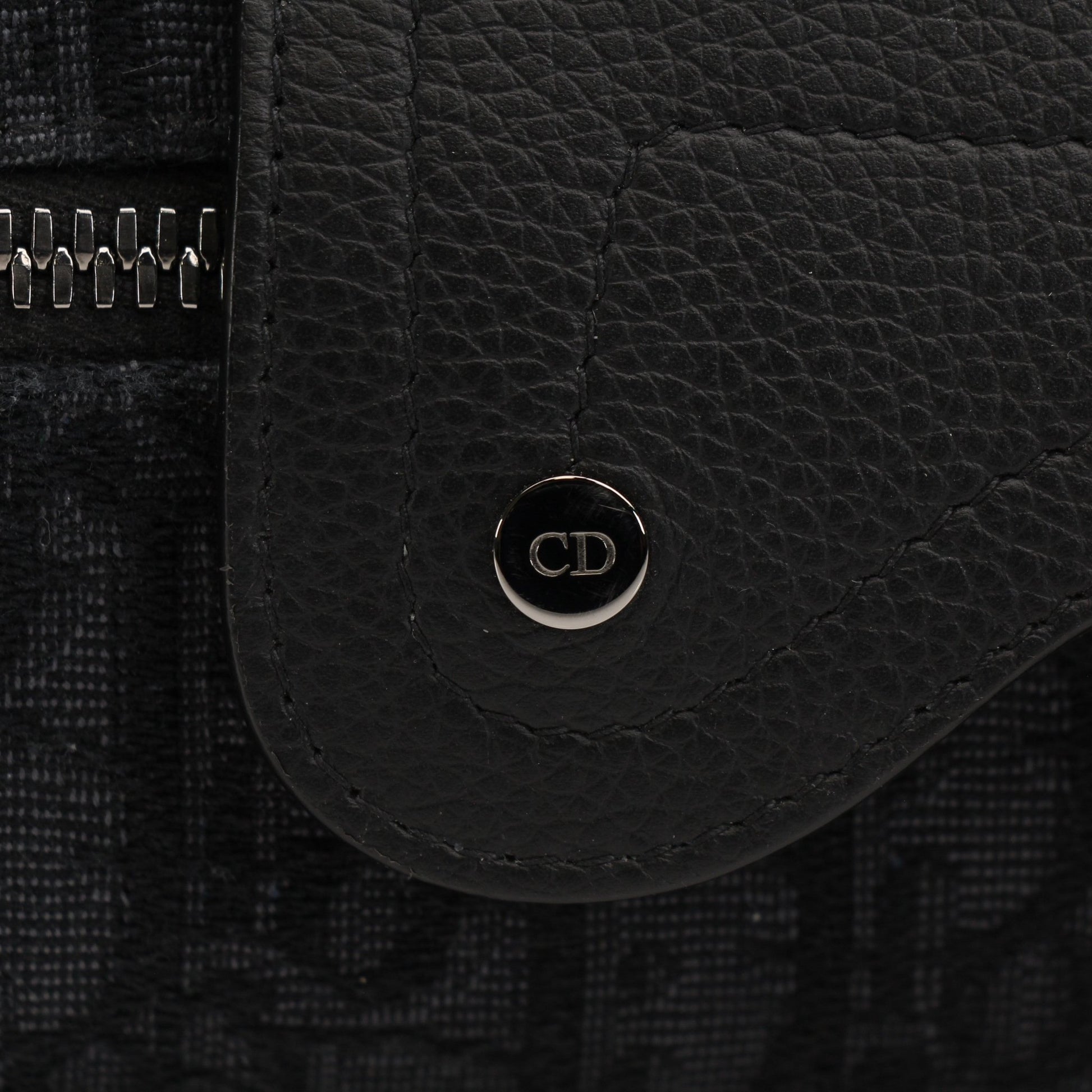 Christian Dior Dior Oblique toiletry bag with gold accents, featuring a sleek design and Dior branding for elegant travel storage.