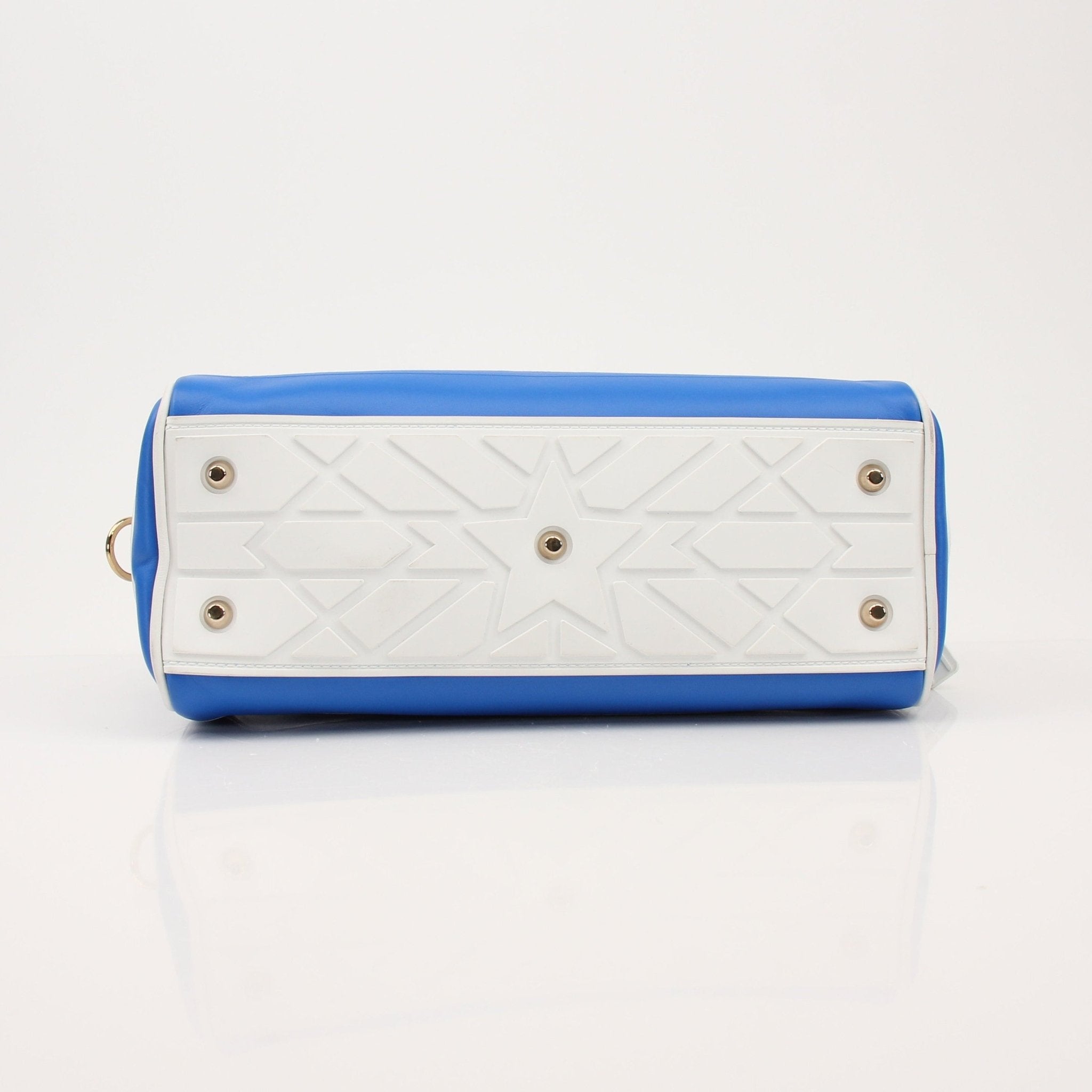 Blue Christian Dior bowling handbag with gold accents, featuring a structured design and top handle for elegant carrying.