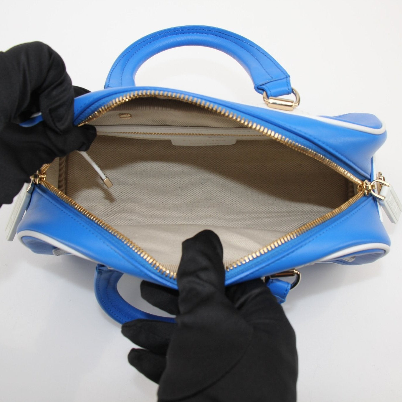 Christian Dior blue bowling handbag with gold accents, stylish and spacious, crafted by Gold & Beyond.