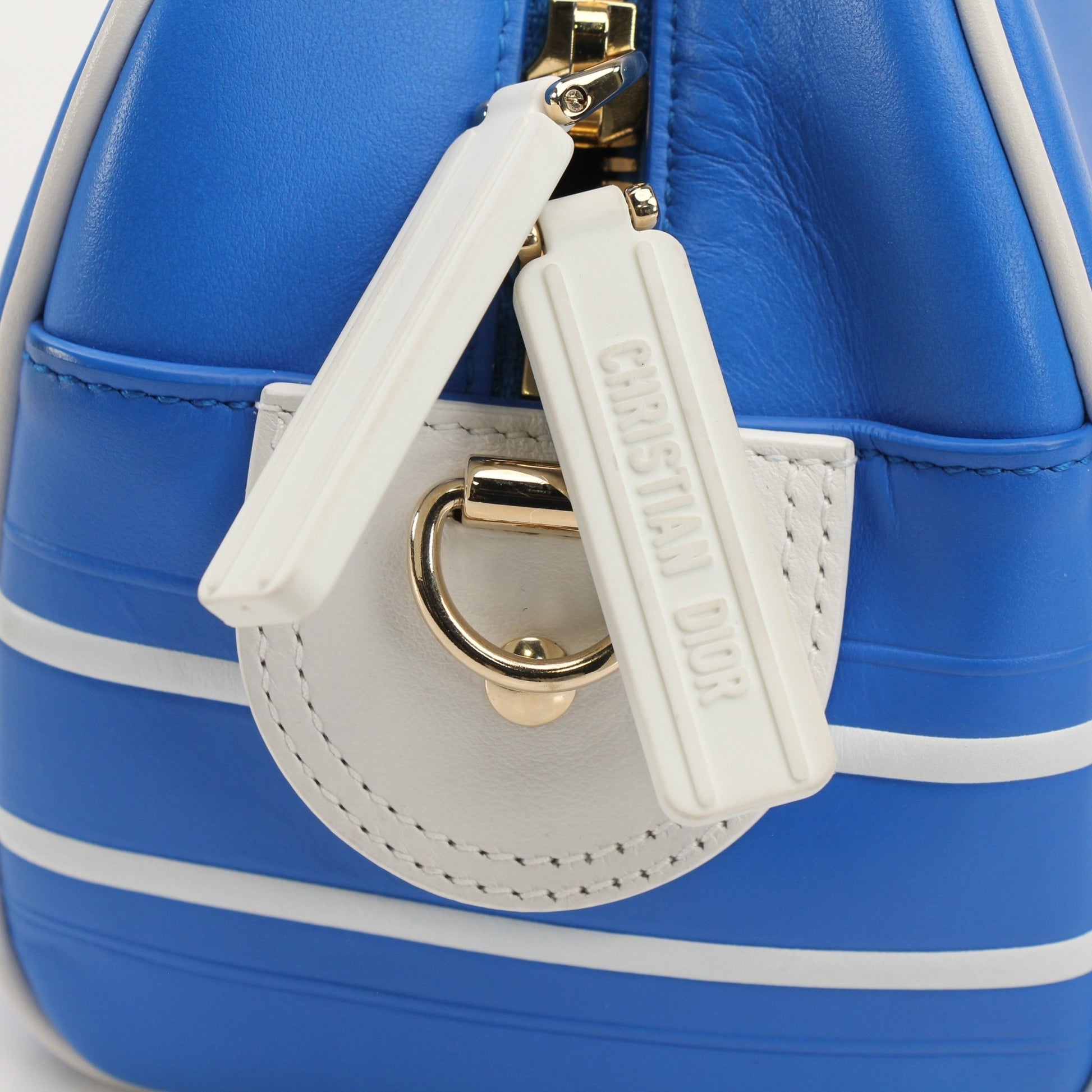 Christian Dior blue bowling handbag by Gold & Beyond, showcasing a stylish designer handbag with sleek blue leather and gold accents.