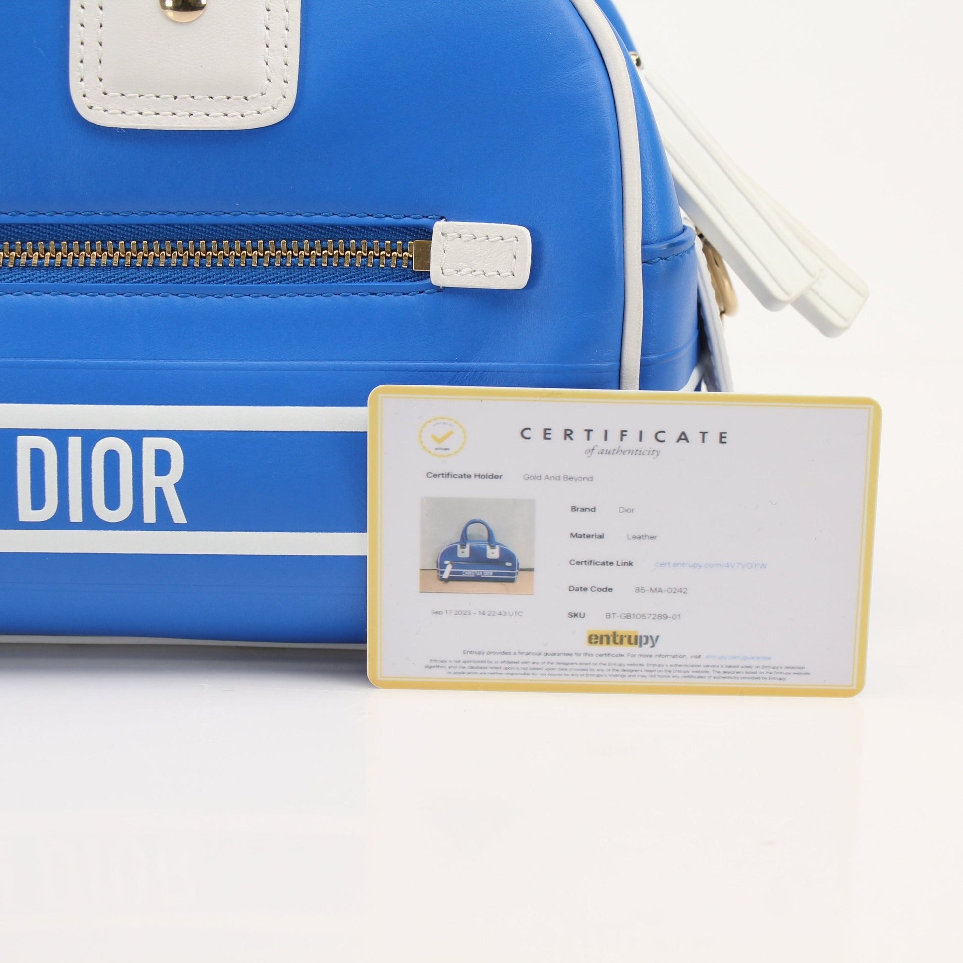 Christian Dior blue bowling handbag with gold accents, stylish and spacious designer handbag for everyday use.