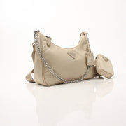 Prada Re-Edition 2005 Re-Nylon shoulder handbag with top handle and strap, featuring sleek black design and Prada logo.