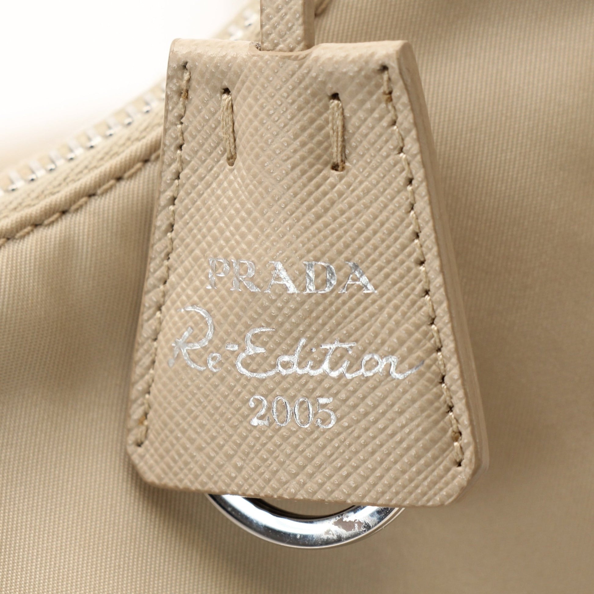 Prada Re-Edition 2005 Re-Nylon shoulder handbag with top handle and silver hardware, displayed on a plain background.