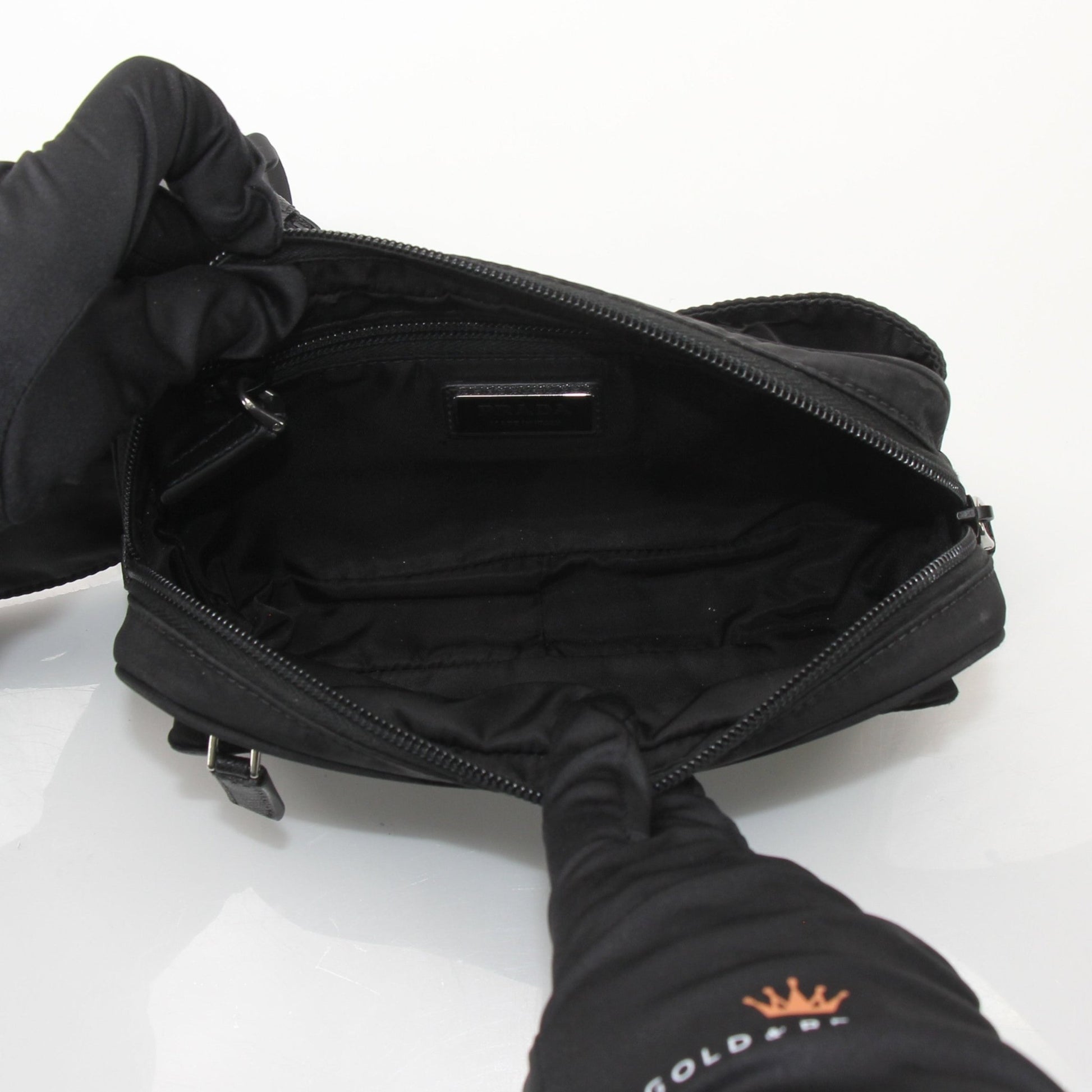 Gold & Beyond Prada Re-Nylon Belt Bag handbag with adjustable strap and logo detail, showcasing its sleek, modern design.
