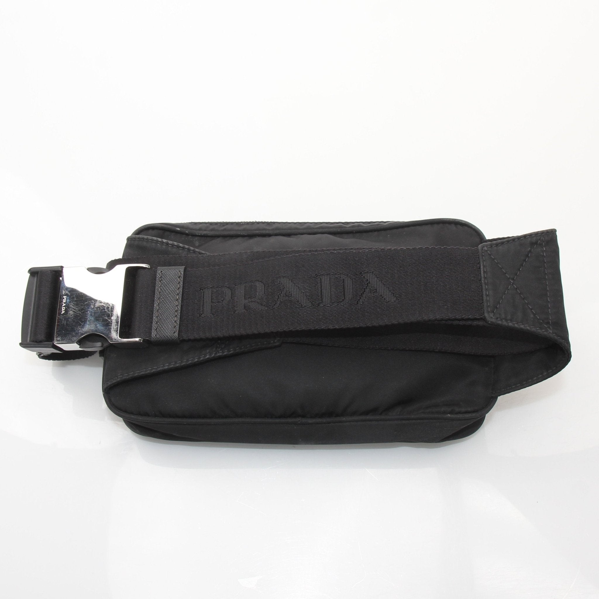 Gold & Beyond Prada Re-Nylon belt bag handbag with adjustable strap and sleek design, showcasing versatile fashion style.