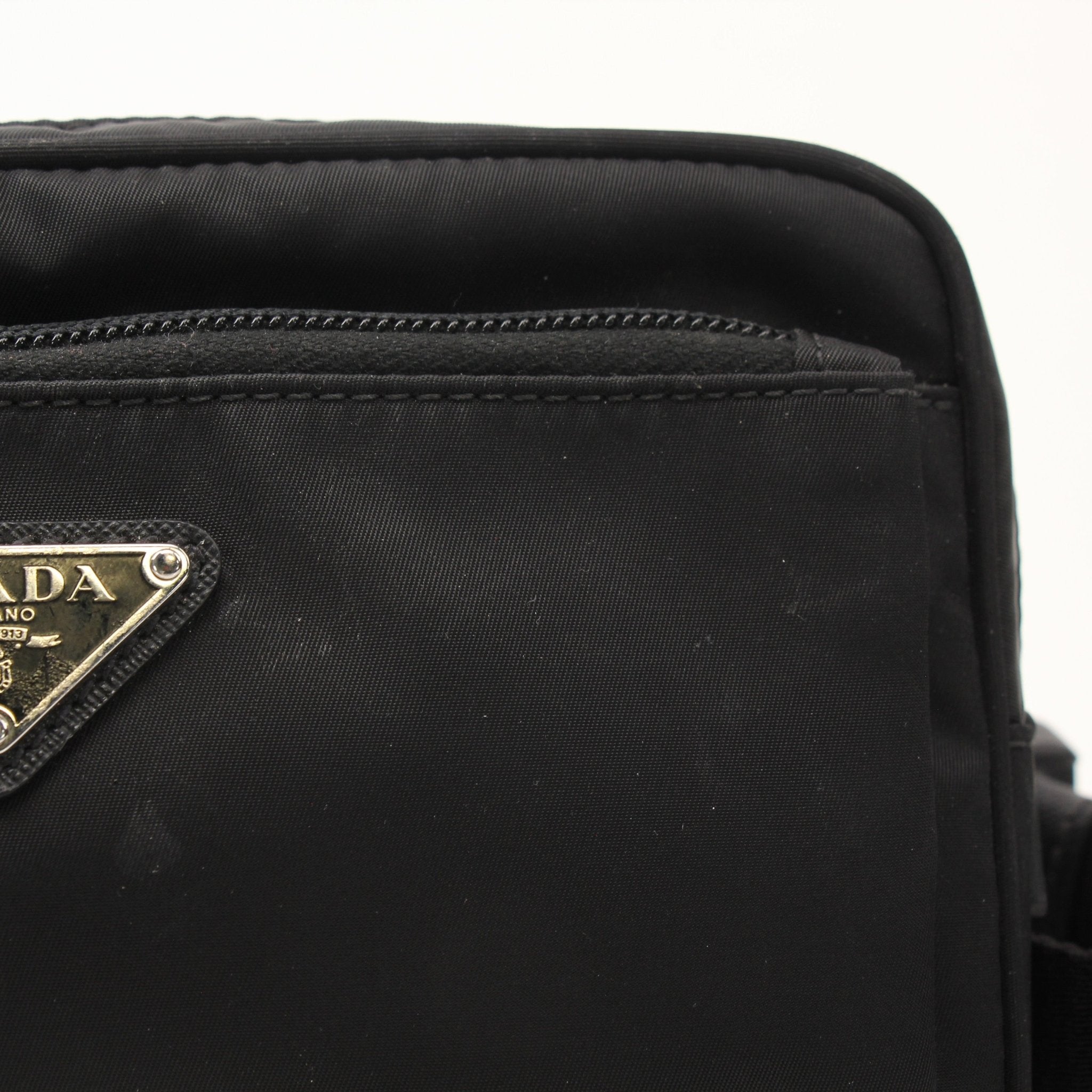 Gold & Beyond Prada Re-Nylon Belt Bag handbag with adjustable strap, logo detail, and sleek design, made from eco-friendly nylon material.