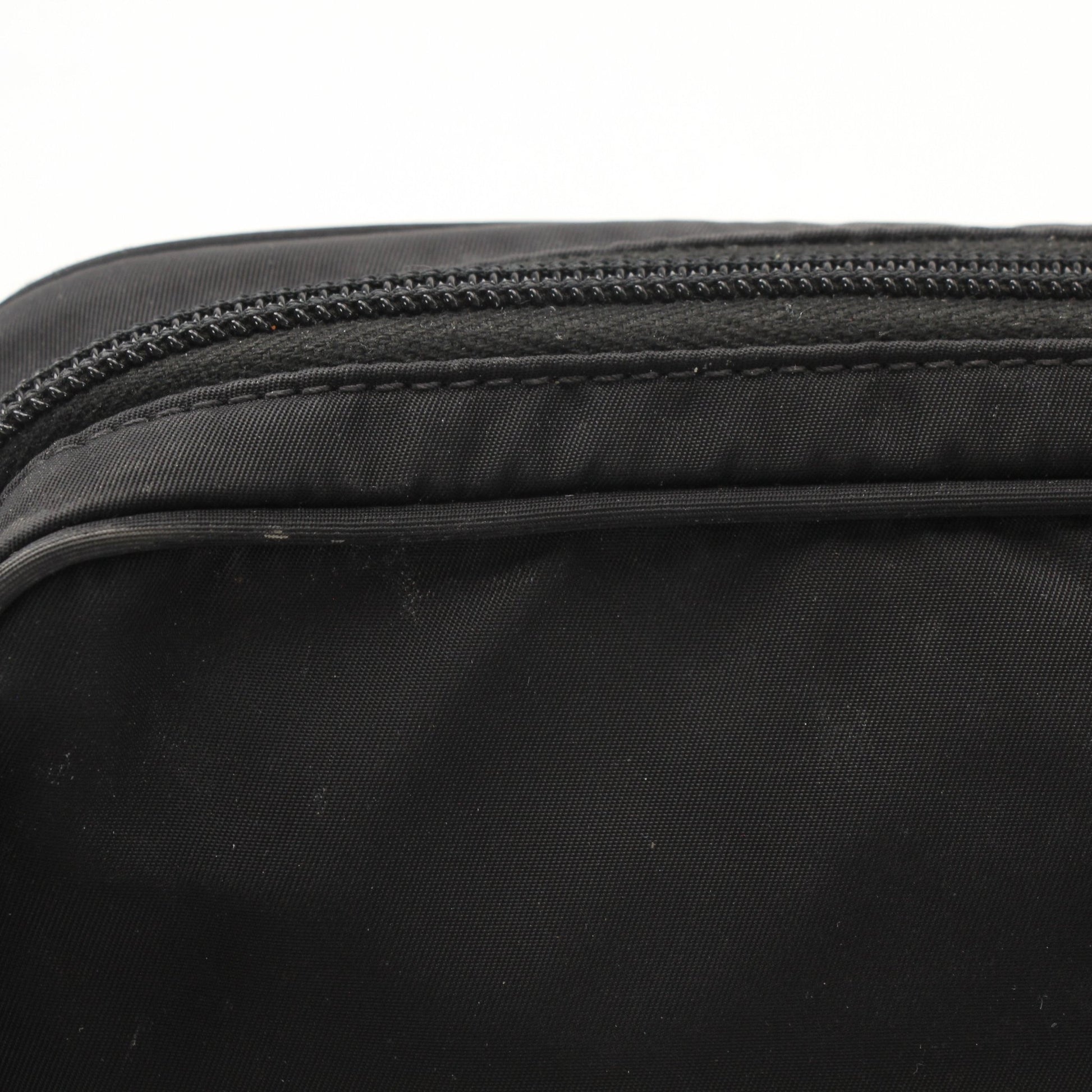Prada Re-Nylon belt bag by Gold & Beyond, showing a stylish black handbag with adjustable strap and Prada logo detail.