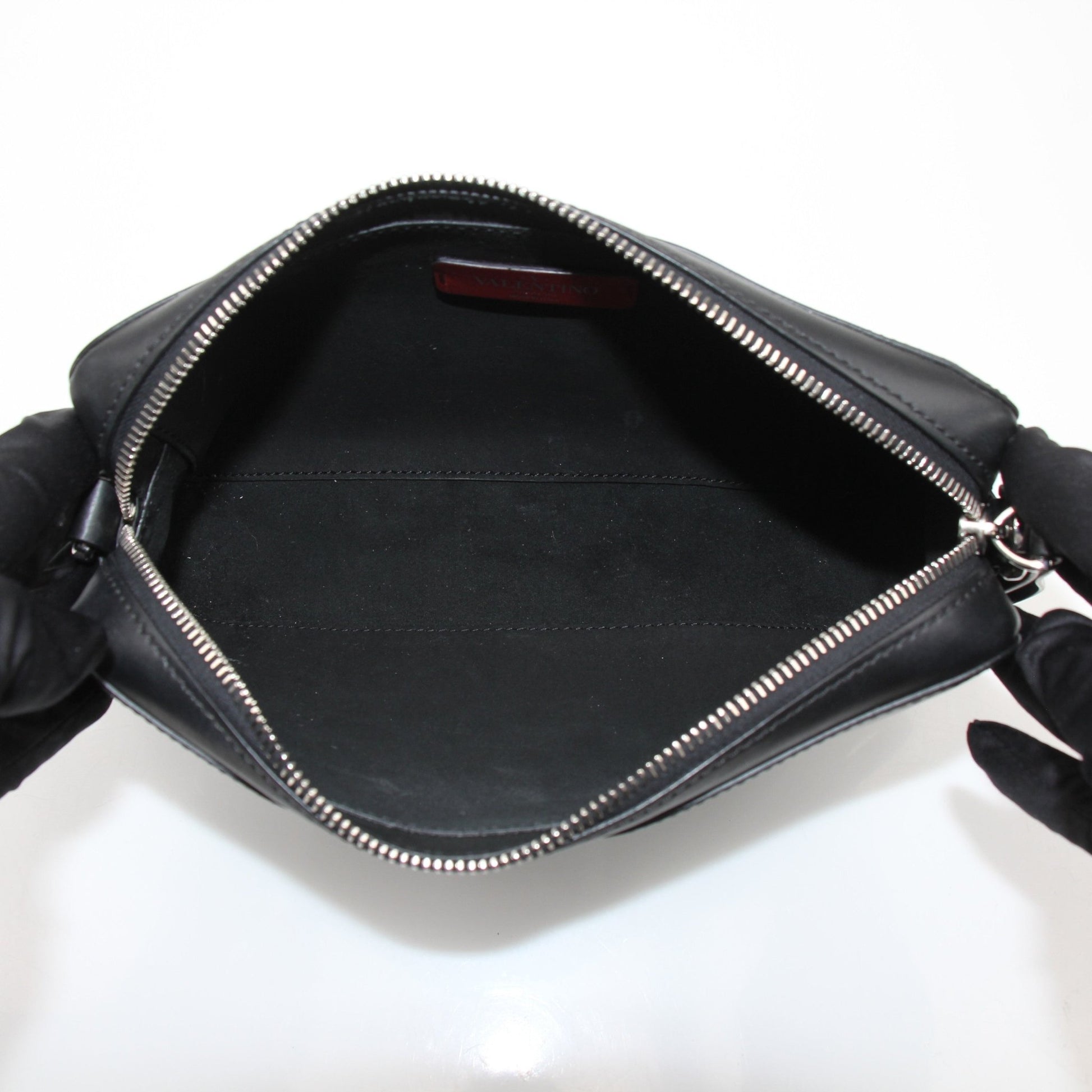 Gold & Beyond Valentino black crossbody handbag with sleek design and adjustable strap, shown on a white background.
