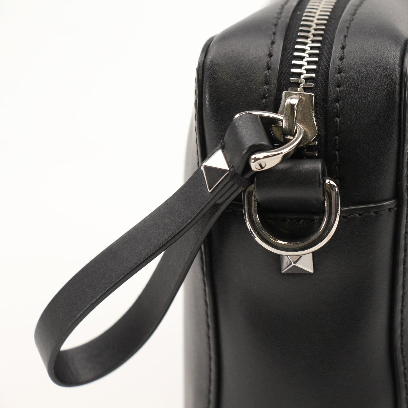 Gold & Beyond Valentino black crossbody handbag with adjustable strap and sleek design, shown in a close-up image.