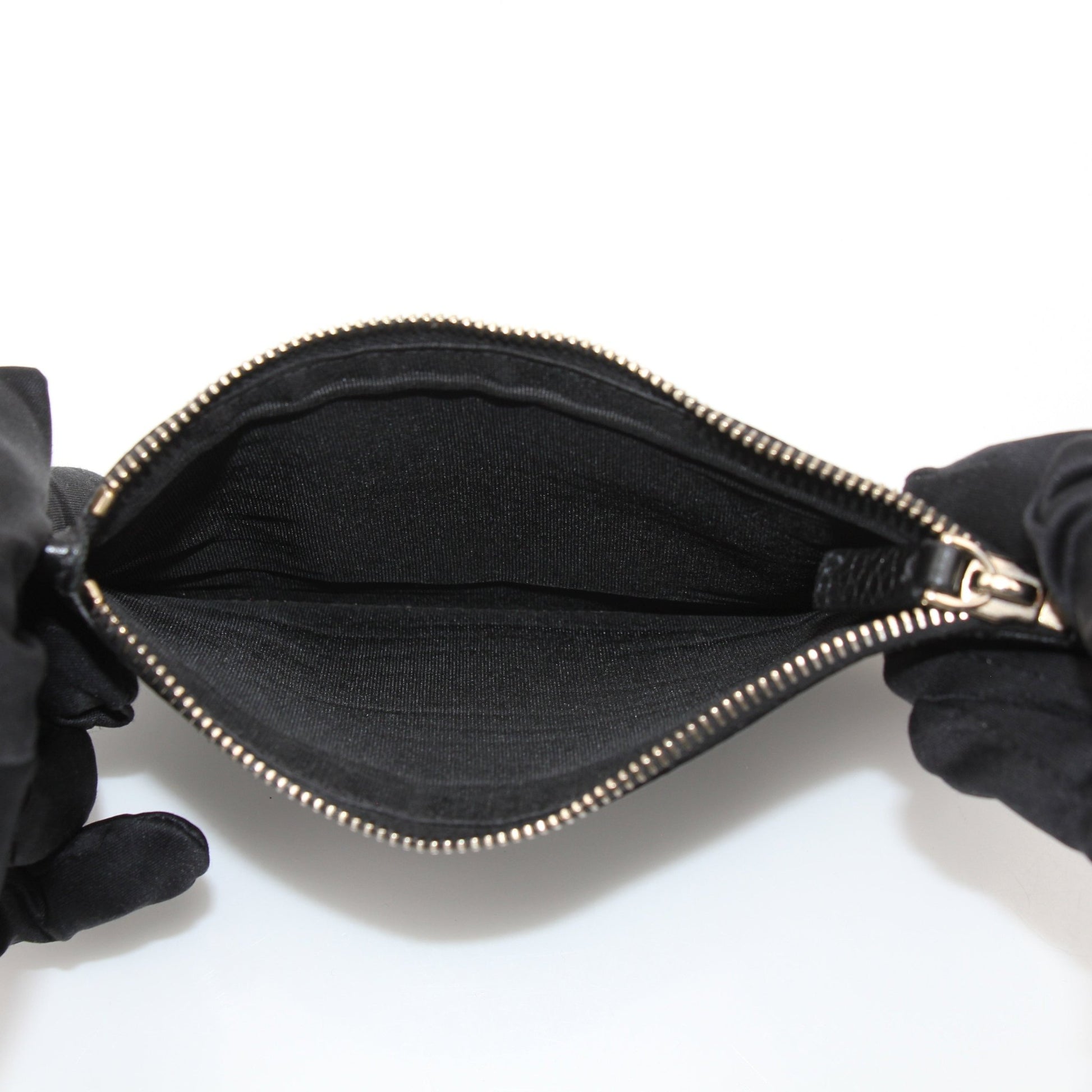 Gold & Beyond Valentino Rockstud Spike Wallet showing black leather design with gold stud accents and multiple card slots.