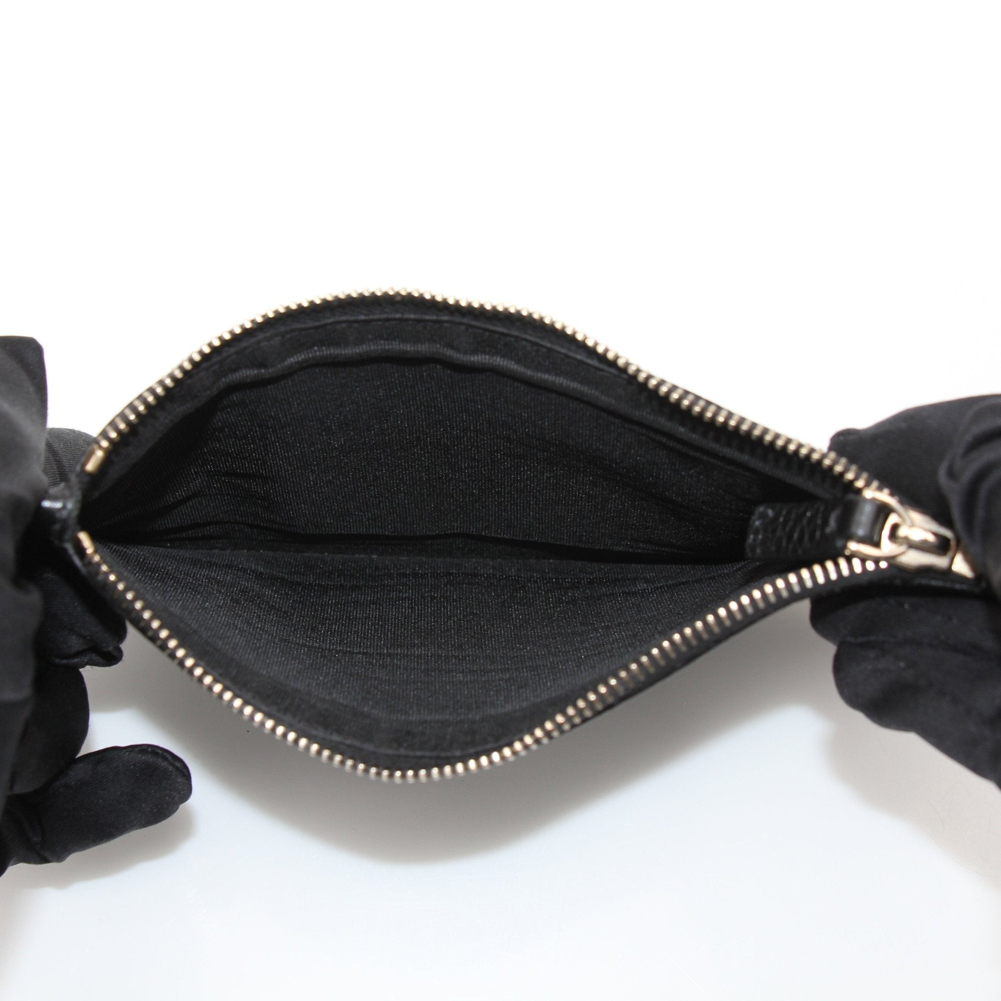 Gold & Beyond Valentino Rockstud Spike Wallet showing black leather design with gold stud accents and multiple card slots.