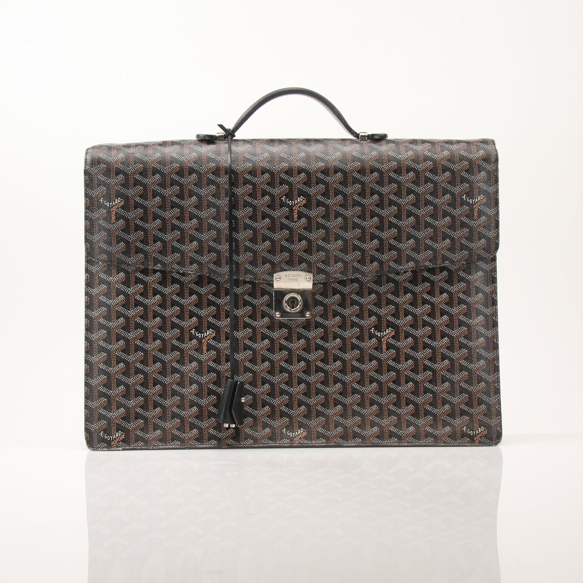 Gold & Beyond Goyard Serviette Chypre leather briefcase handbag with sleek design and top handle, detailed stitching visible.