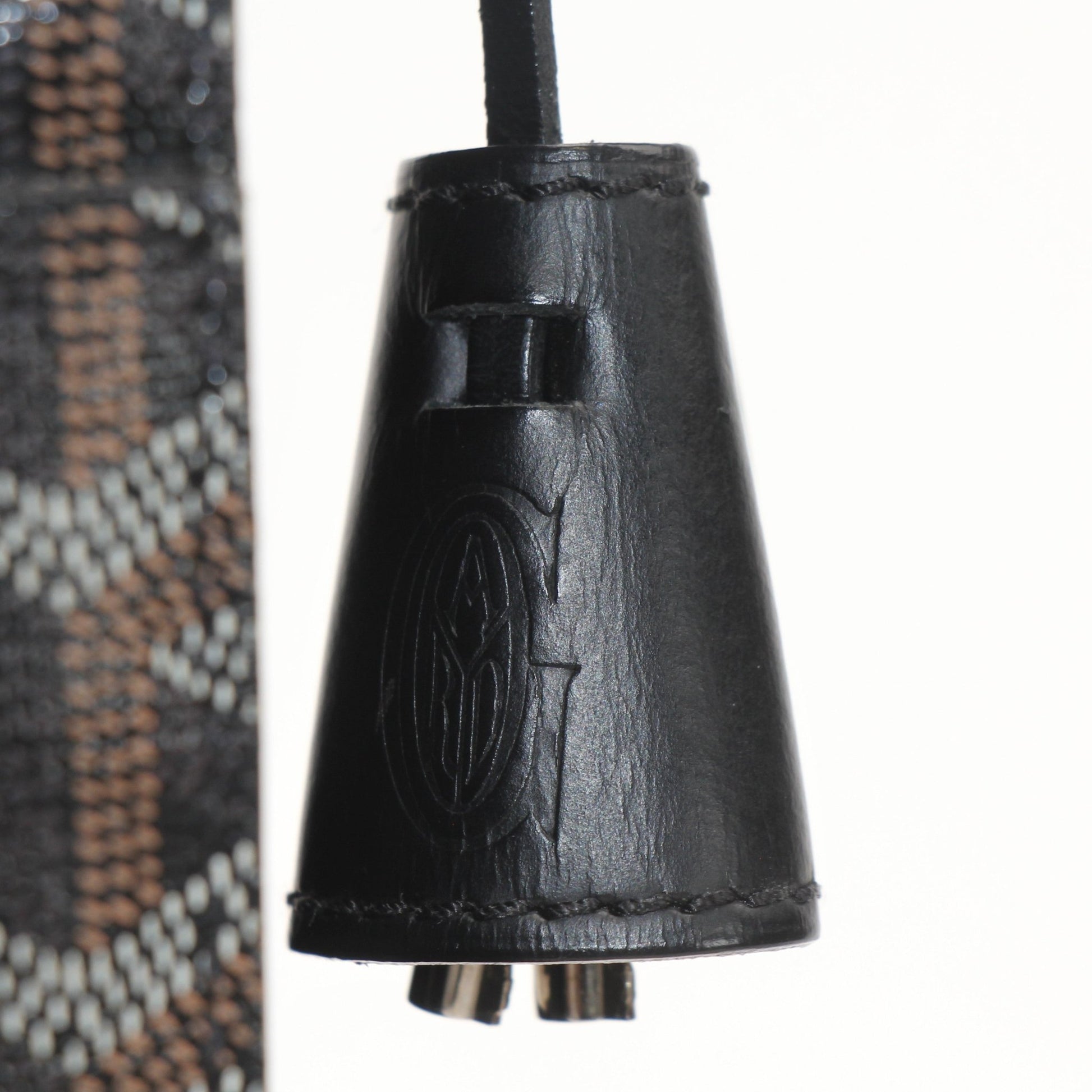 Gold & Beyond Goyard Serviette Chypre handbag with tan leather accents and Goyard pattern, shown on a flat surface.