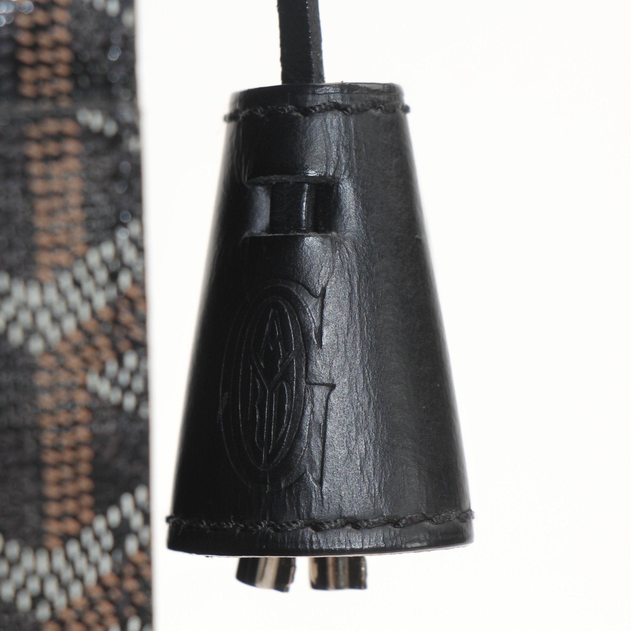 Gold & Beyond Goyard Serviette Chypre handbag with tan leather accents and Goyard pattern, shown on a flat surface.