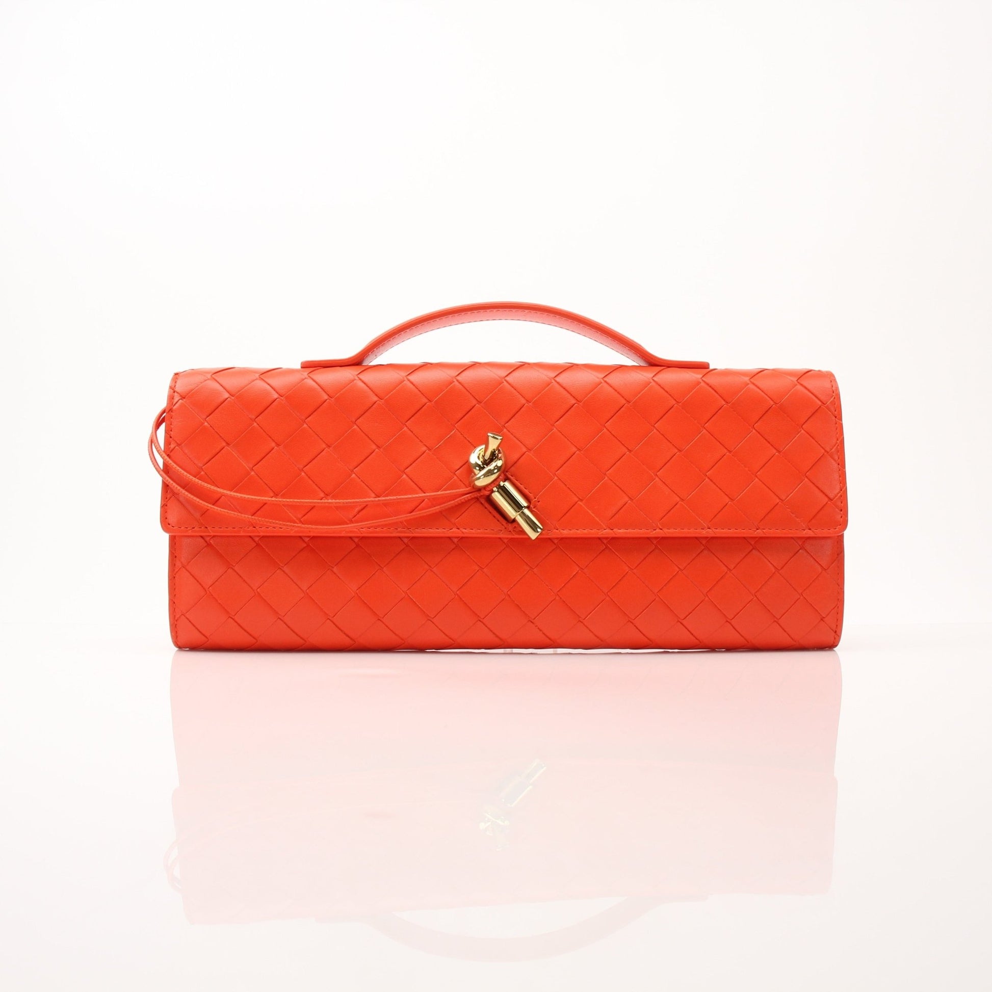 Gold & Beyond Bottega Veneta Andiamo clutch handbag with textured leather and sleek design, shown in a close-up image.