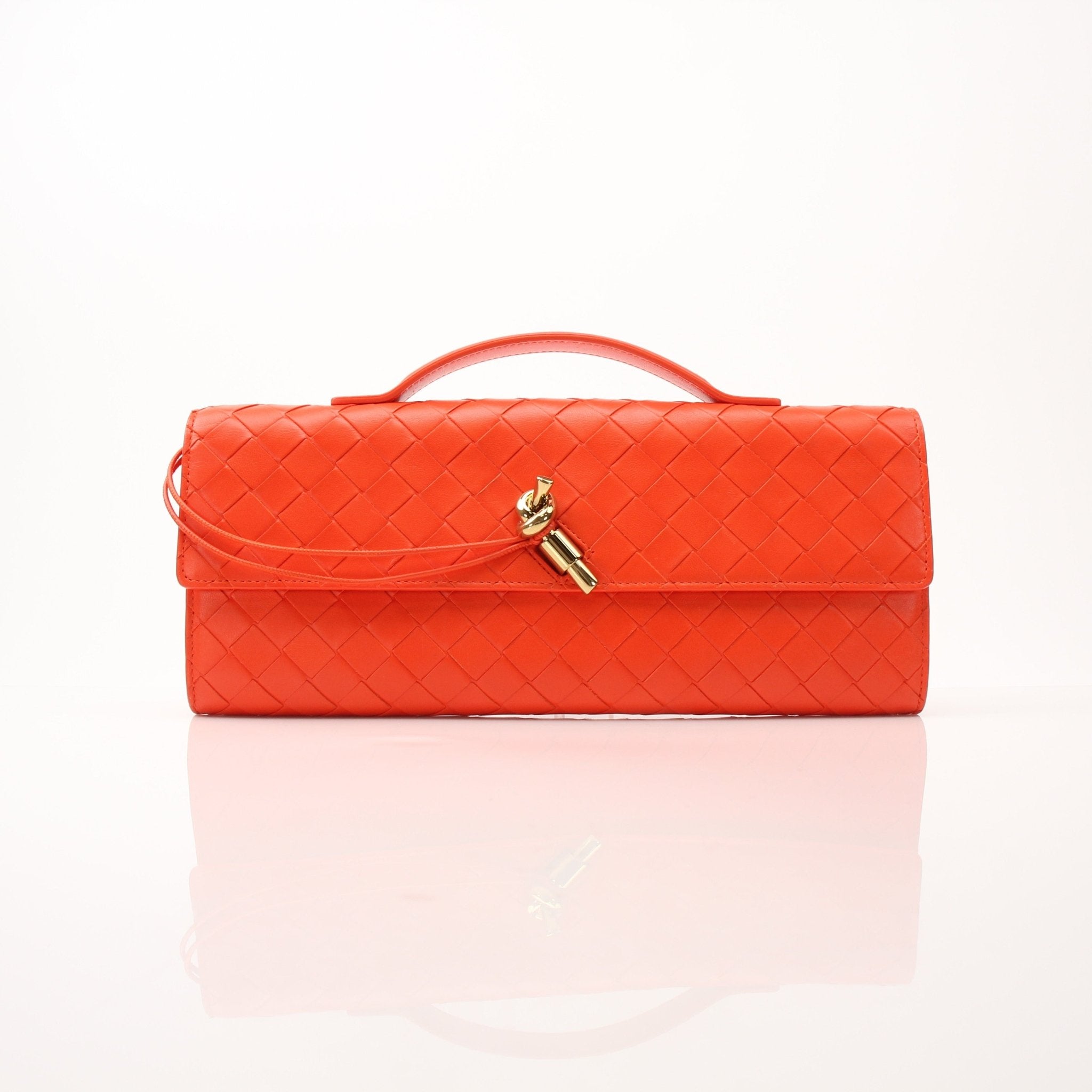 Gold & Beyond Bottega Veneta Andiamo clutch handbag with textured leather and sleek design, shown in a close-up image.