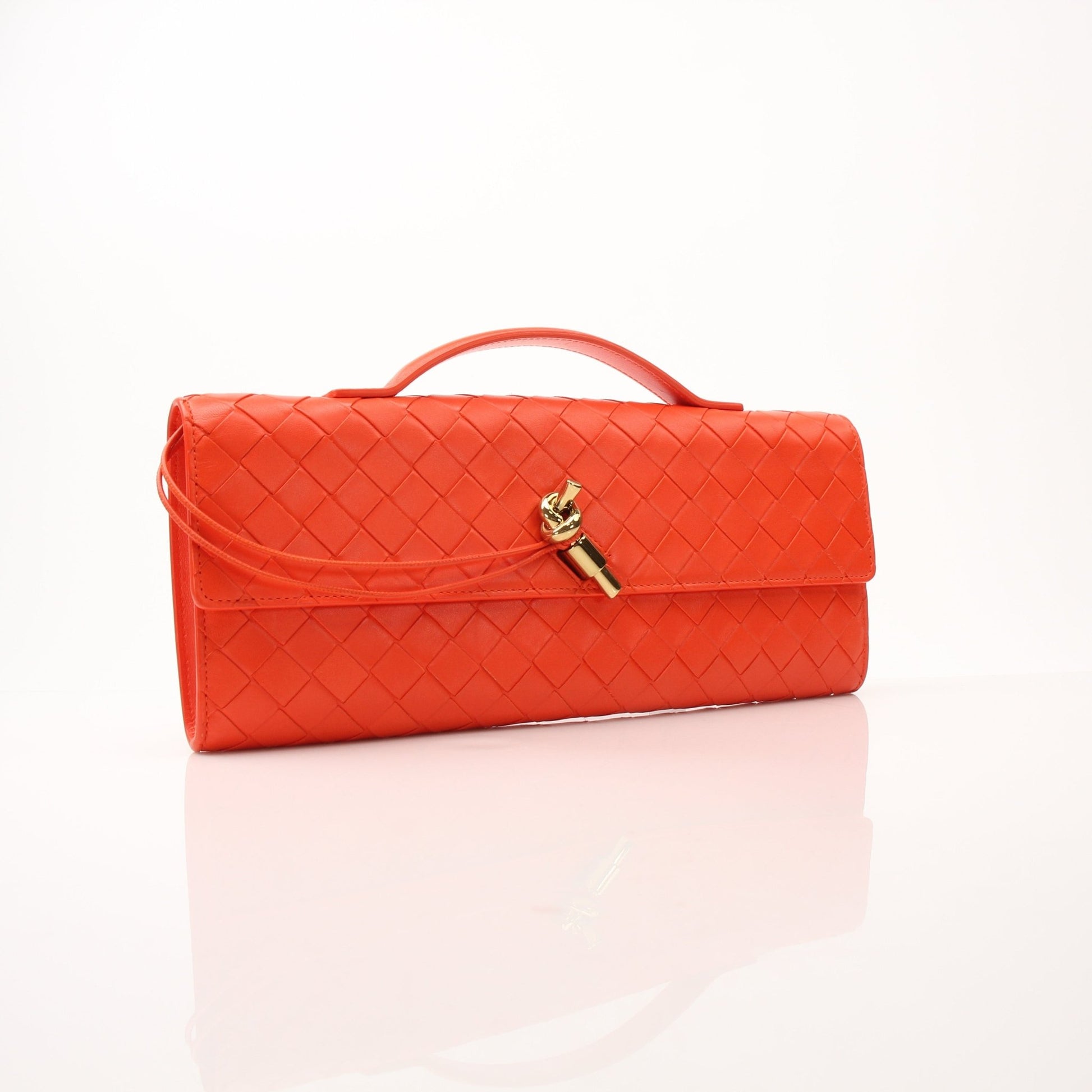 Gold Bottega Veneta Andiamo clutch handbag with sleek design and gold-tone accents, displayed on a neutral background.