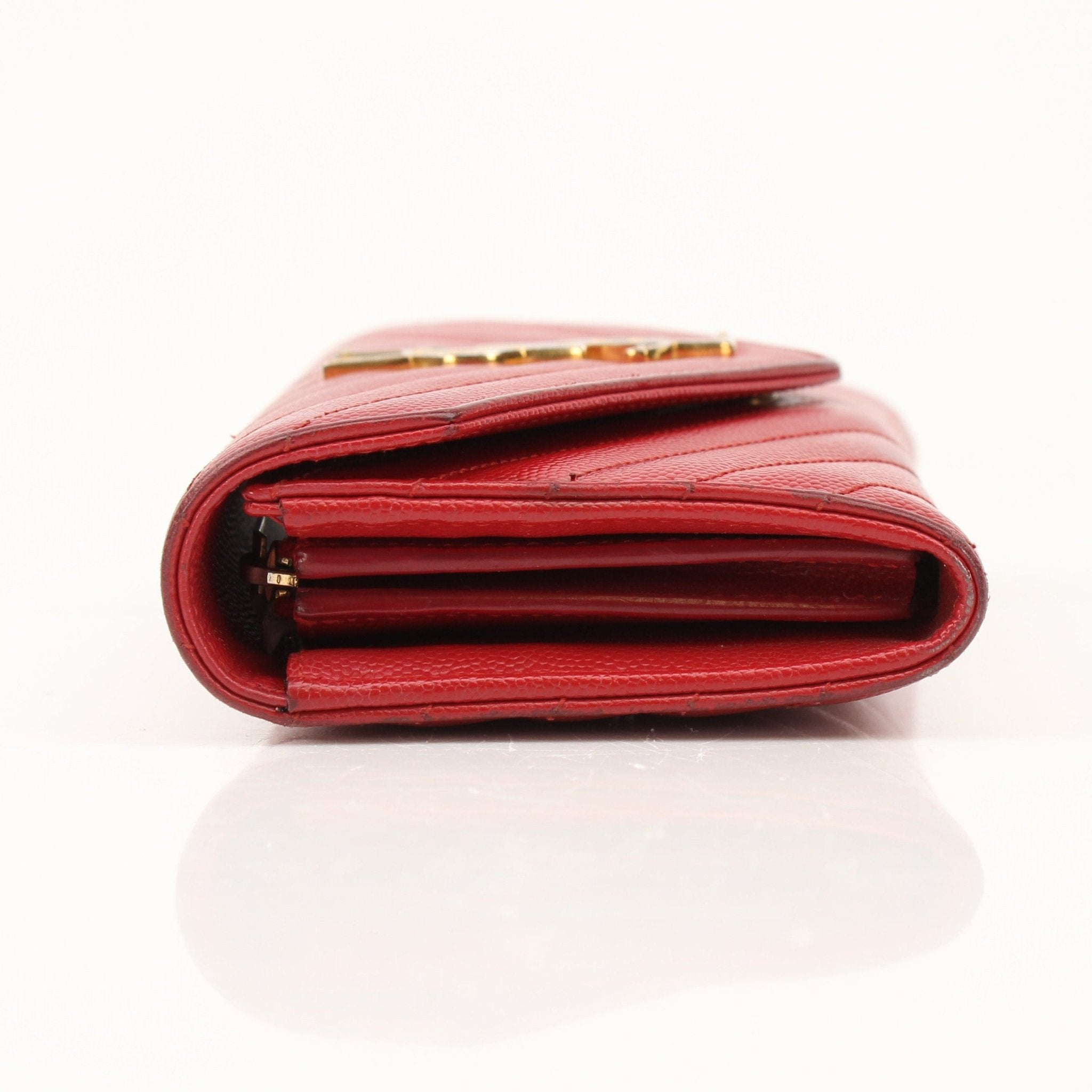 Red Saint Laurent envelope chain wallet with flap closure, featuring gold hardware and compact design.