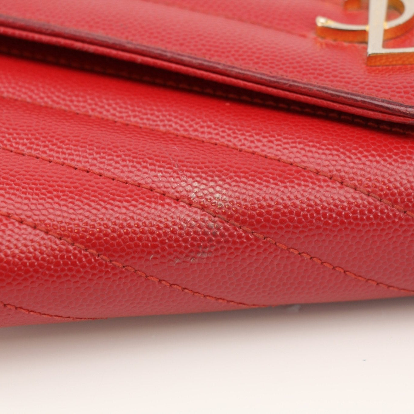 Gold & Beyond Saint Laurent red envelope chain wallet with flap, showcasing a sleek design and elegant chain strap.