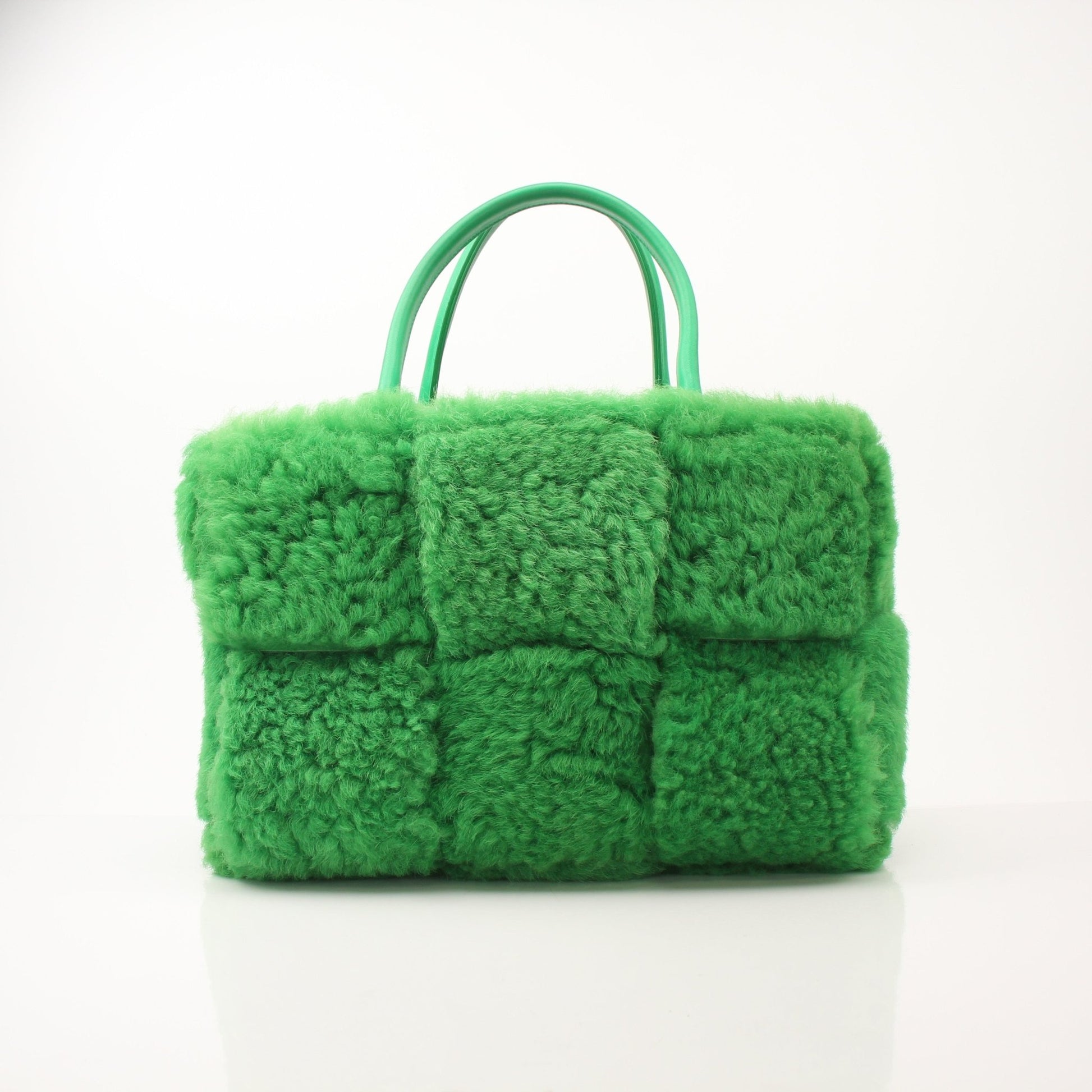 Green Bottega Veneta Arco Tote handbag with structured design and top handles, showcased by Gold & Beyond.