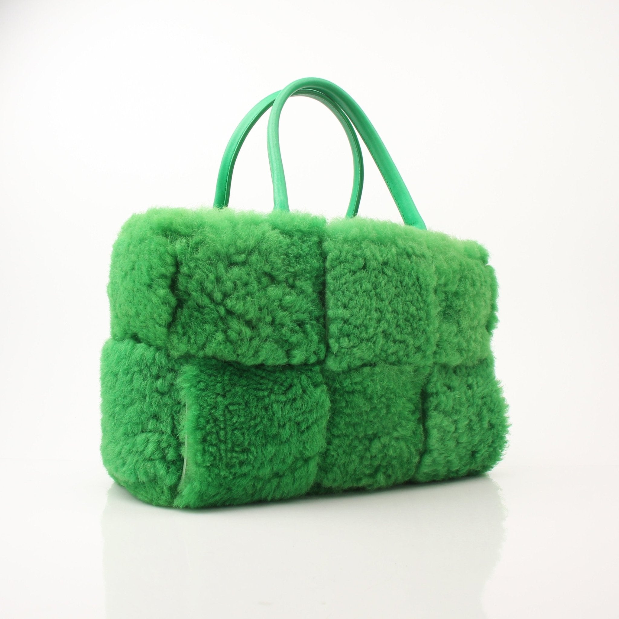Green Bottega Veneta Arco Tote handbag with structured design and top handles, featuring a smooth leather finish.